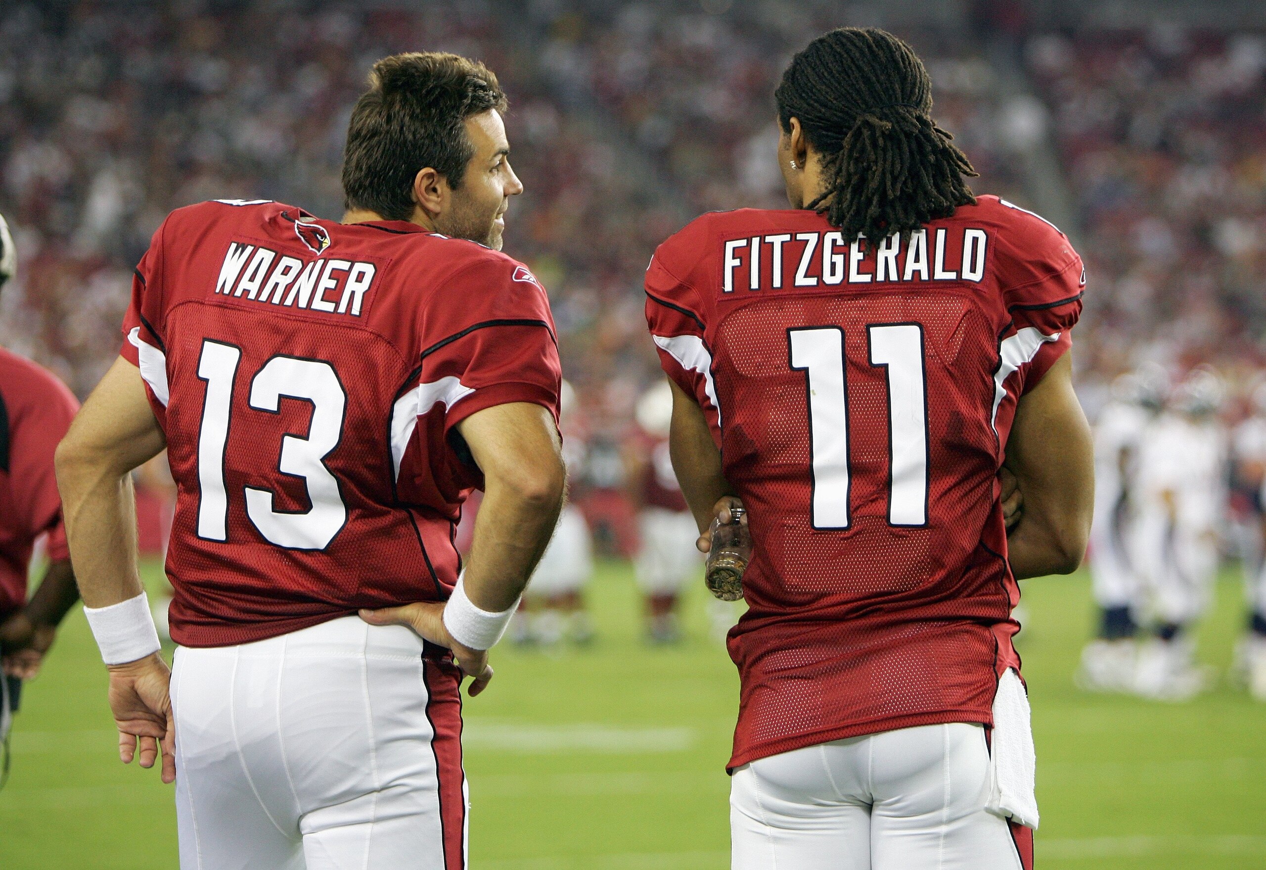 GLENDALE, AZ - AUGUST 31:  Quarterback Kurt Warner #13 and Larry Fitzgerald #11 of the Arizona Cardinals talk on the sidelines during the game against the Denver Broncos on August 31, 2006 at Cardinals Stadium in Glendale, Arizona.  The Broncos defeated t