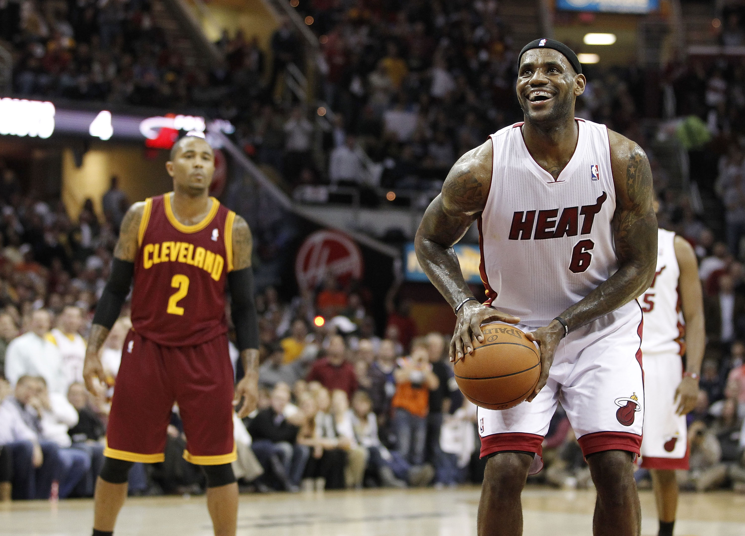 CLEVELAND, OH - DECEMBER 02:  LeBron James #6 of the Miami Heat smiles while takeing a free throw in front of Mo Williams #2 of the Cleveland Cavaliers at Quicken Loans Arena on December 2, 2010 in Cleveland, Ohio. NOTE TO USER: User expressly acknowledge