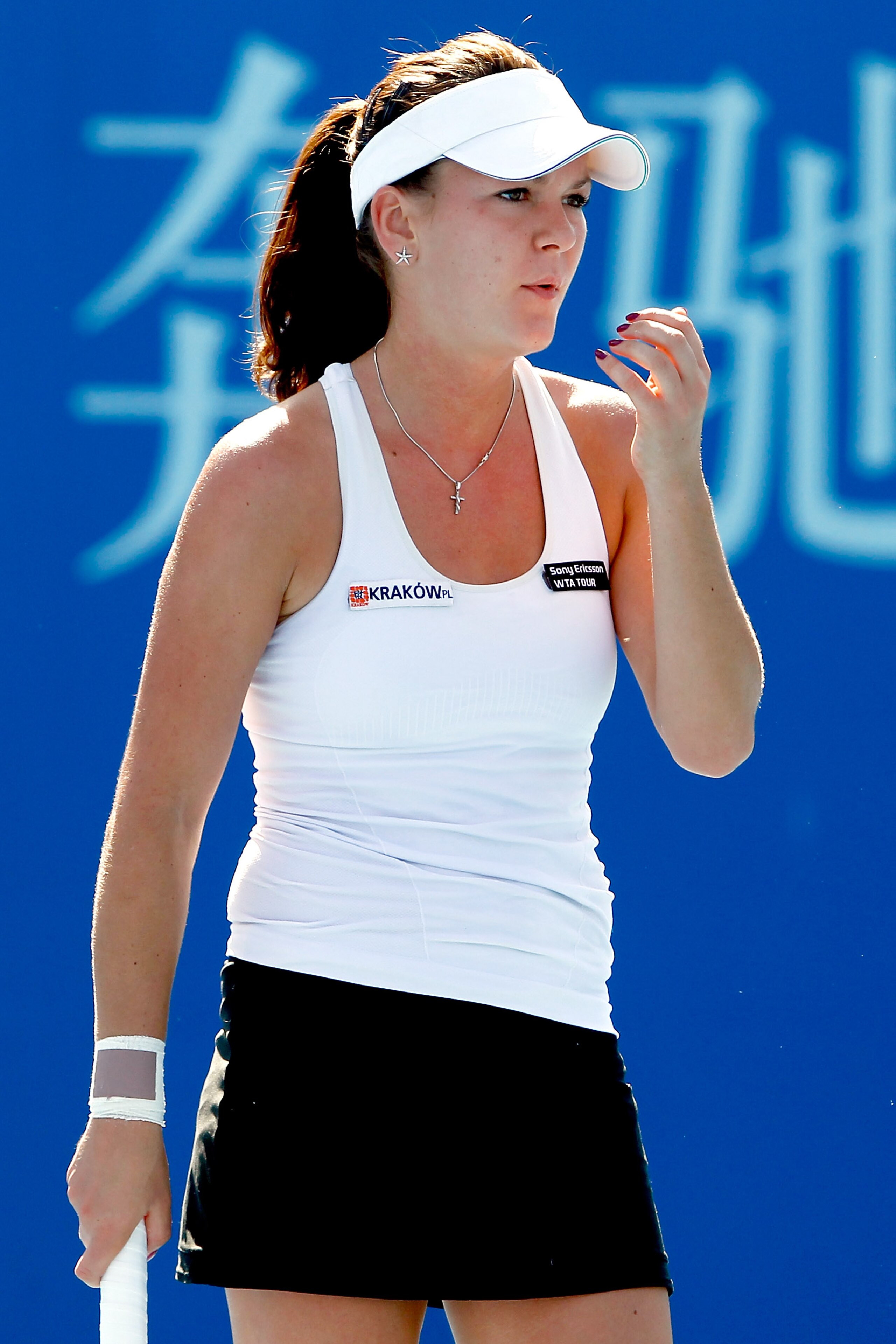 BEIJING - OCTOBER 04:  Agnieszka Radwanska of Poland drys her hands between points while playing Angelique Kerber of Germany during day four of the 2010 China Open at the National Tennis Center on October 4, 2010 in Beijing, China.  (Photo by Matthew Stoc