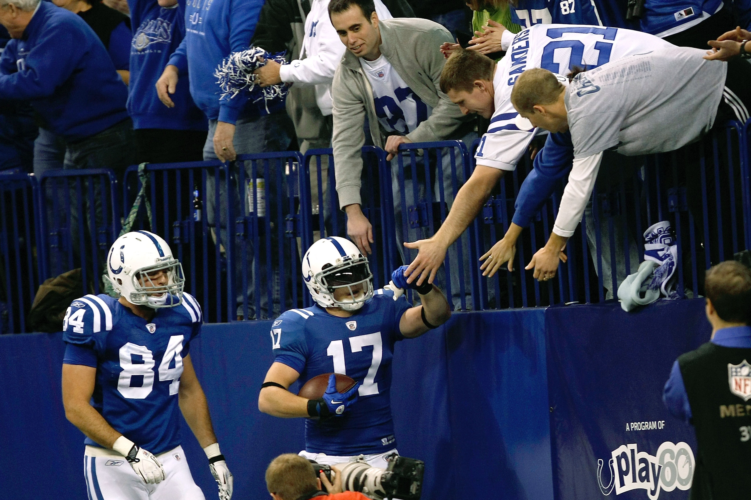 INDIANAPOLIS, IN - DECEMBER 19: Austin Collie #17 of the Indianapolis Colts celebrates with fans after scoring a touchdown as Jacob Tamme #84 looks on against the Jacksonville Jaguars at Lucas Oil Stadium on December 19, 2010 in Indianapolis, Indiana.  (P