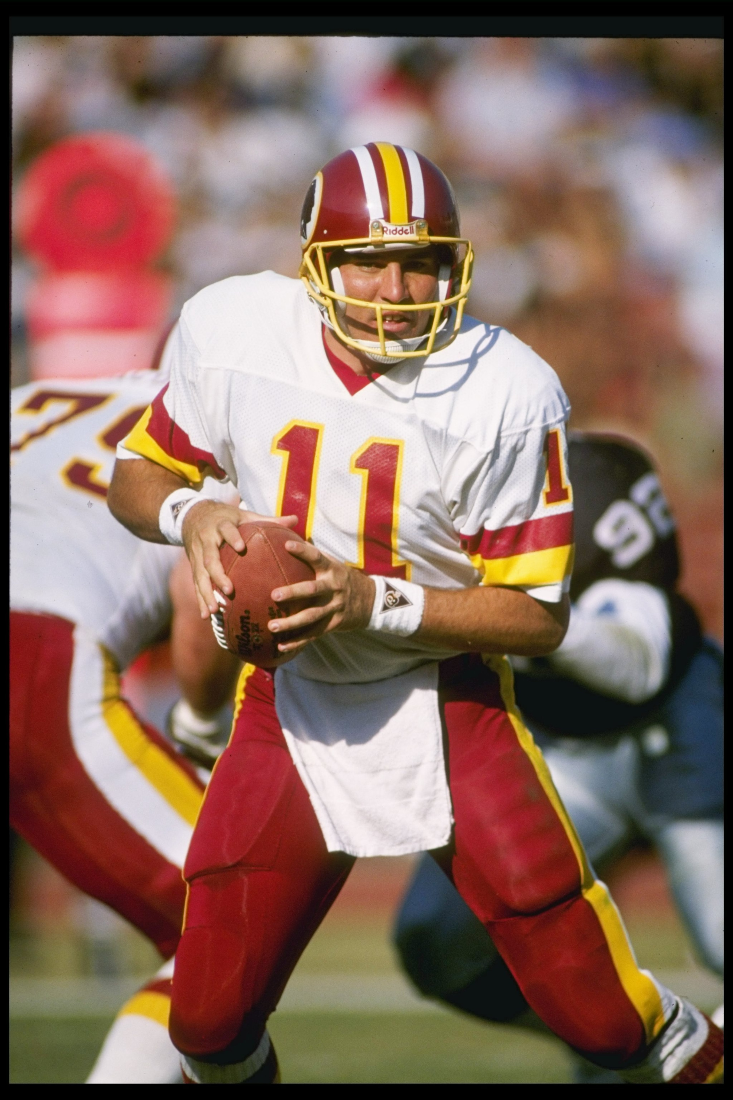 29 Oct 1989:  Quarterback Mark Rypien of the Washington Redskins looks to pass the ball during a game against the Los Angeles Raiders at the Los Angeles Memorial Coliseum in Los Angeles, California.  The Raiders won the game, 37-24. Mandatory Credit: Step
