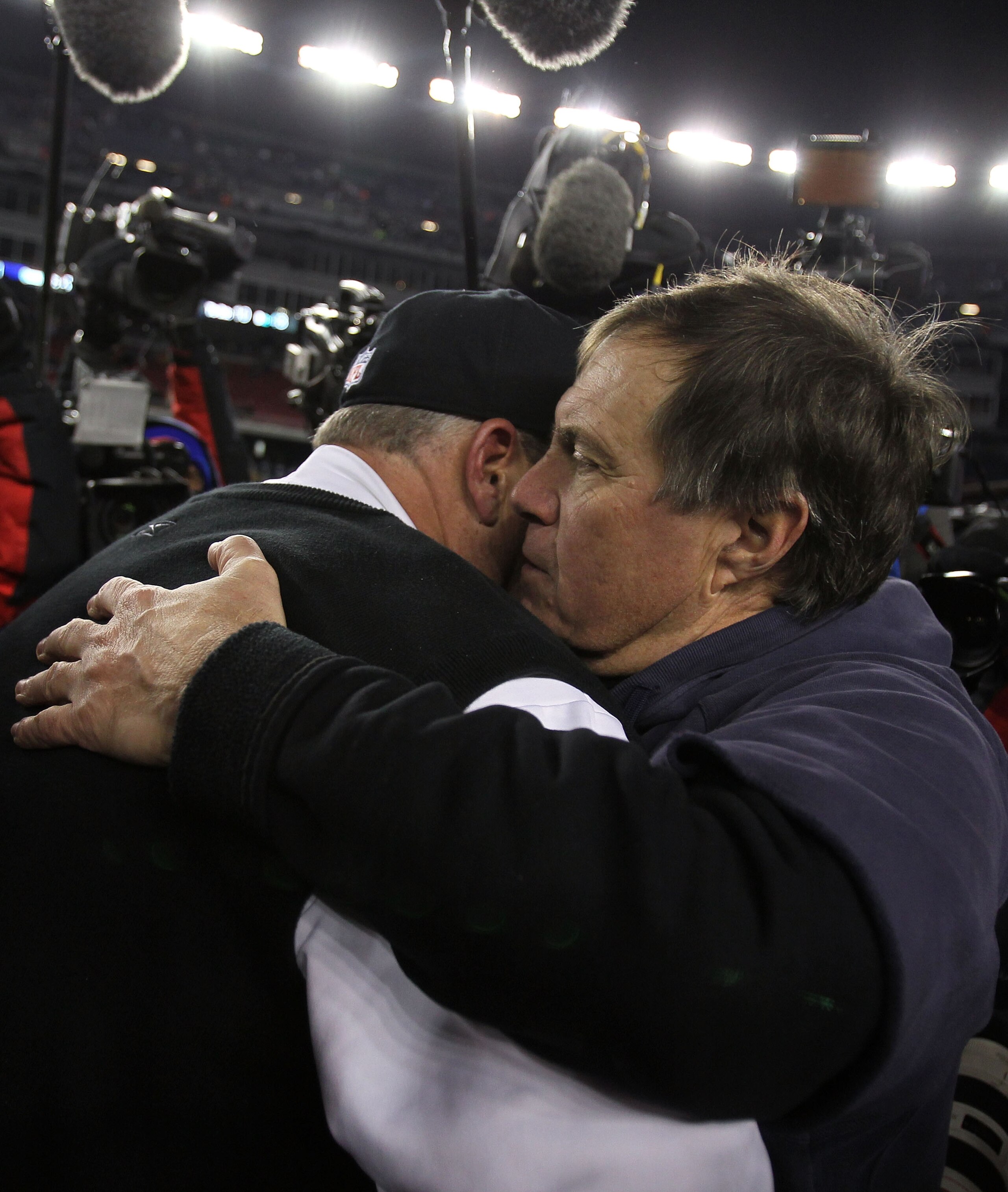 FOXBORO, MA - JANUARY 16:  Head coach Rex Ryan of the New York Jets hugs head coach Bill Belichick of the New England Patriots after the Jets defeated the Patriots 28 to 21 in their 2011 AFC divisional playoff game at Gillette Stadium on January 16, 2011