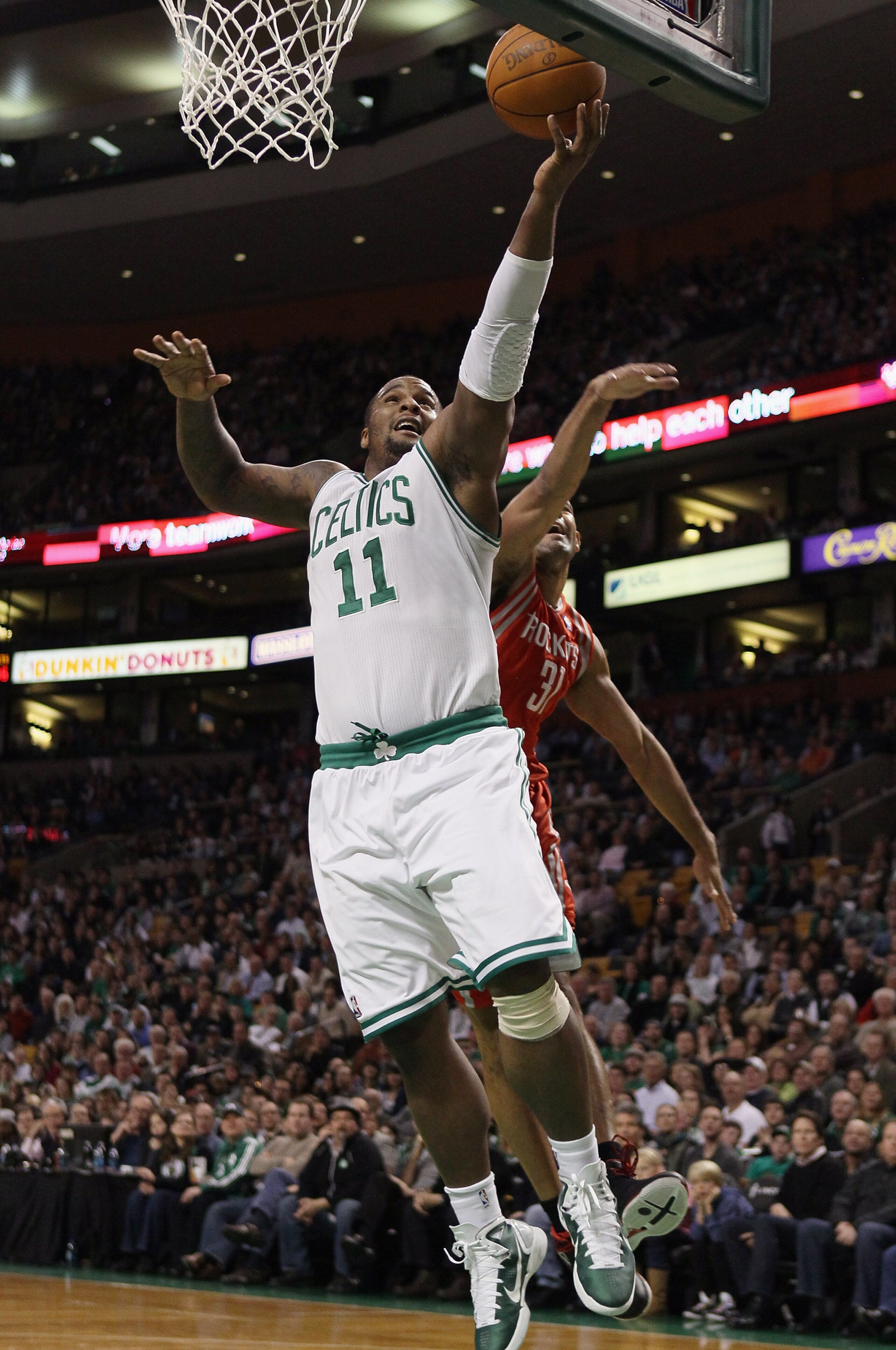 BOSTON, MA - JANUARY 10:  Glen Davis #11 of the Boston Celtics heads to the net as Shane Battier #31 of the Houston Rockets defends on January 10, 2011 at the TD Garden in Boston, Massachusetts.  NOTE TO USER: User expressly acknowledges and agrees that,