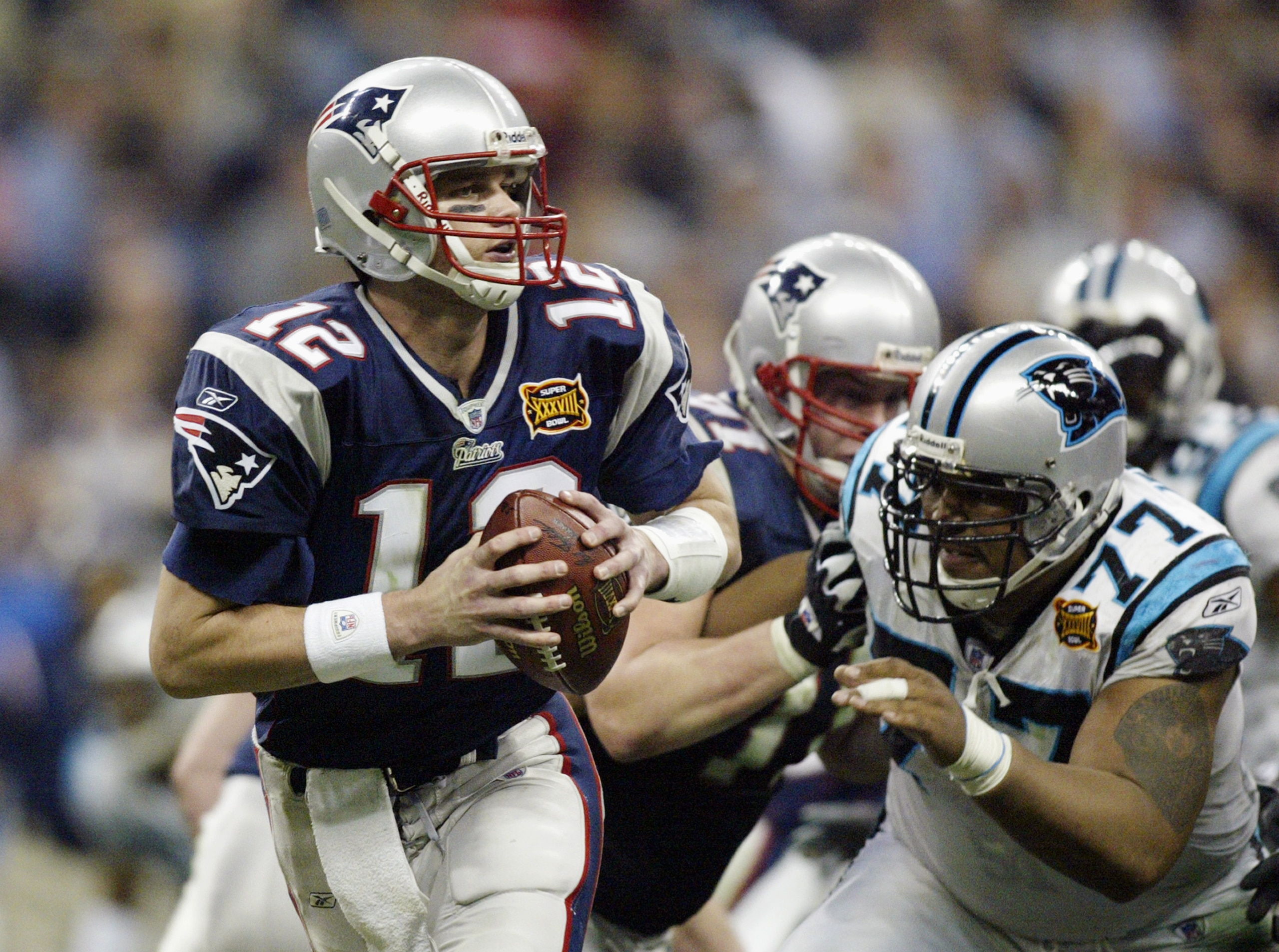 HOUSTON, TX - FEBRUARY 1: Quarterback Tom Brady #12 of the New England Patriots with the ball against the Carolina Panthers during Super Bowl XXXVIII at Reliant Stadium on February 1, 2004 in Houston, Texas. The Patriots won 32-29 to claim their second S HOUSTON, TX - FEBRUARY 1: Quarterback Tom Brady #12 of the New England Patriots with the ball against the Carolina Panthers during Super Bowl XXXVIII at Reliant Stadium on February 1, 2004 in Houston, Texas. The Patriots won 32-29 to claim their second S