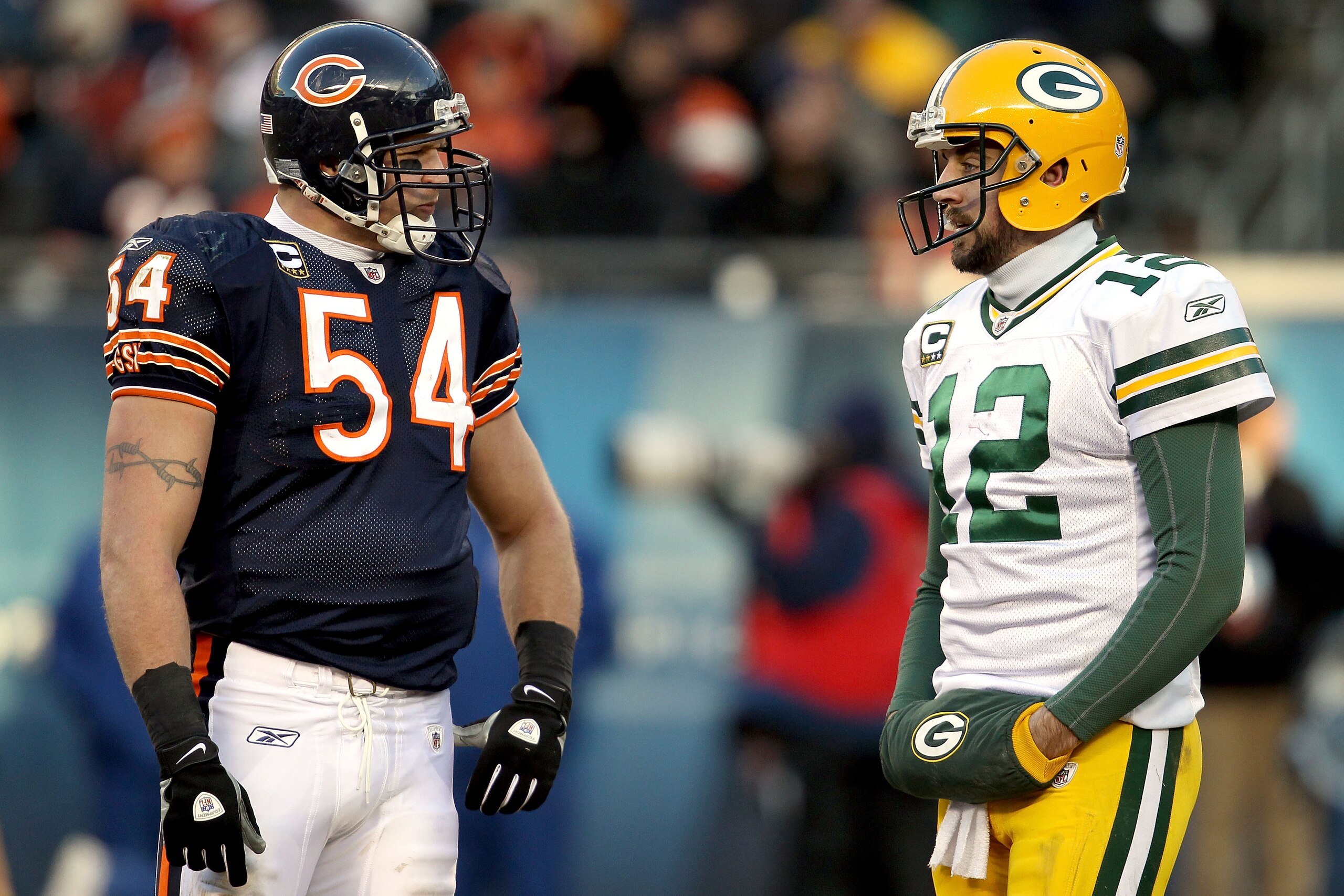 CHICAGO, IL - JANUARY 23:  Linebacker Brian Urlacher #54 of the Chicago Bears talks with quarterback Aaron Rodgers #12 of the Green Bay Packers in the second half of the NFC Championship Game at Soldier Field on January 23, 2011 in Chicago, Illinois.  (Ph