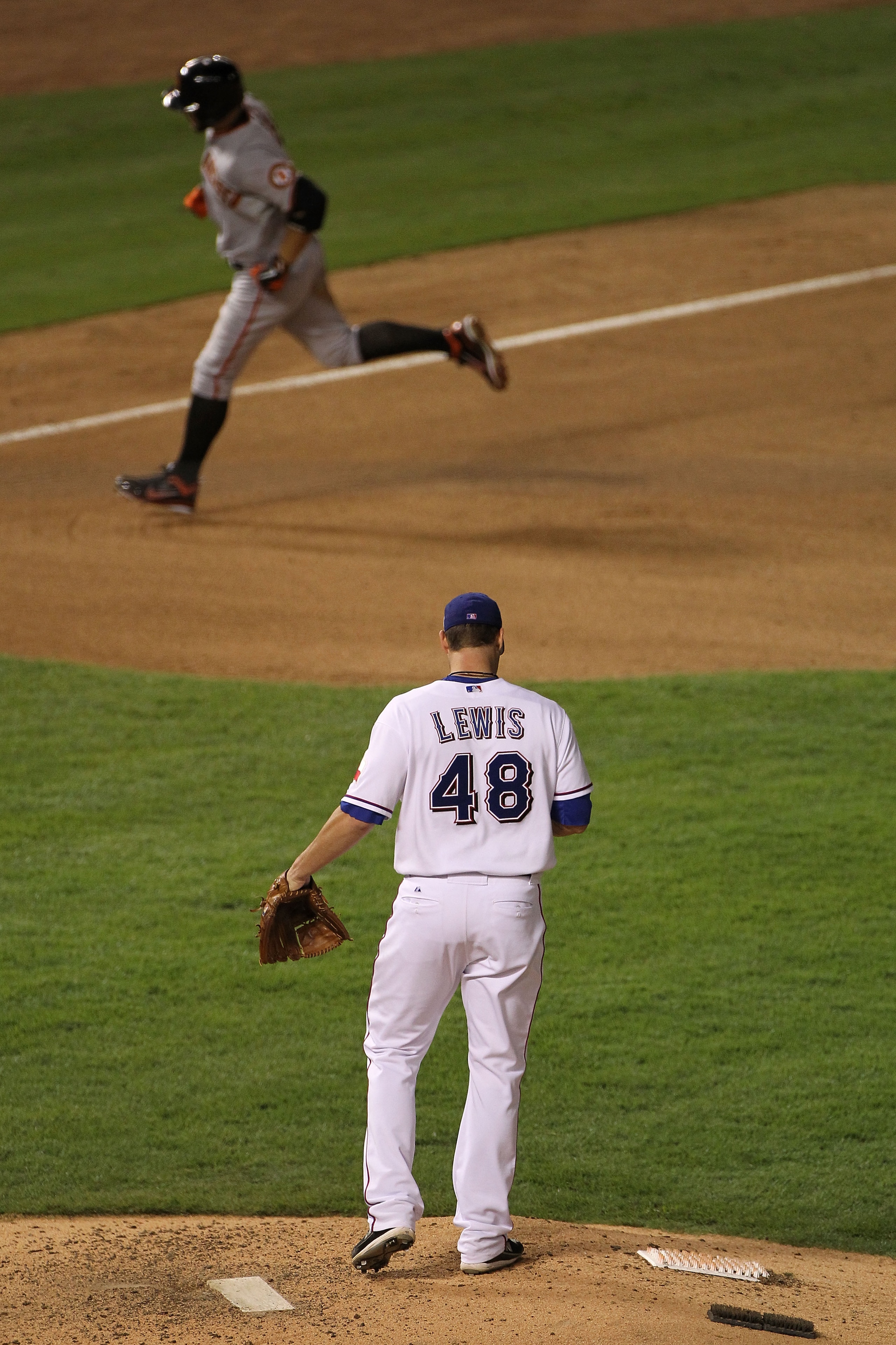 ARLINGTON, TX - OCTOBER 30:  Colby Lewis #48 of the Texas Rangers looks down after giving up a home run to Andres Torres #56 of the San Francisco Giants in Game Three of the 2010 MLB World Series at Rangers Ballpark in Arlington on October 30, 2010 in Arl