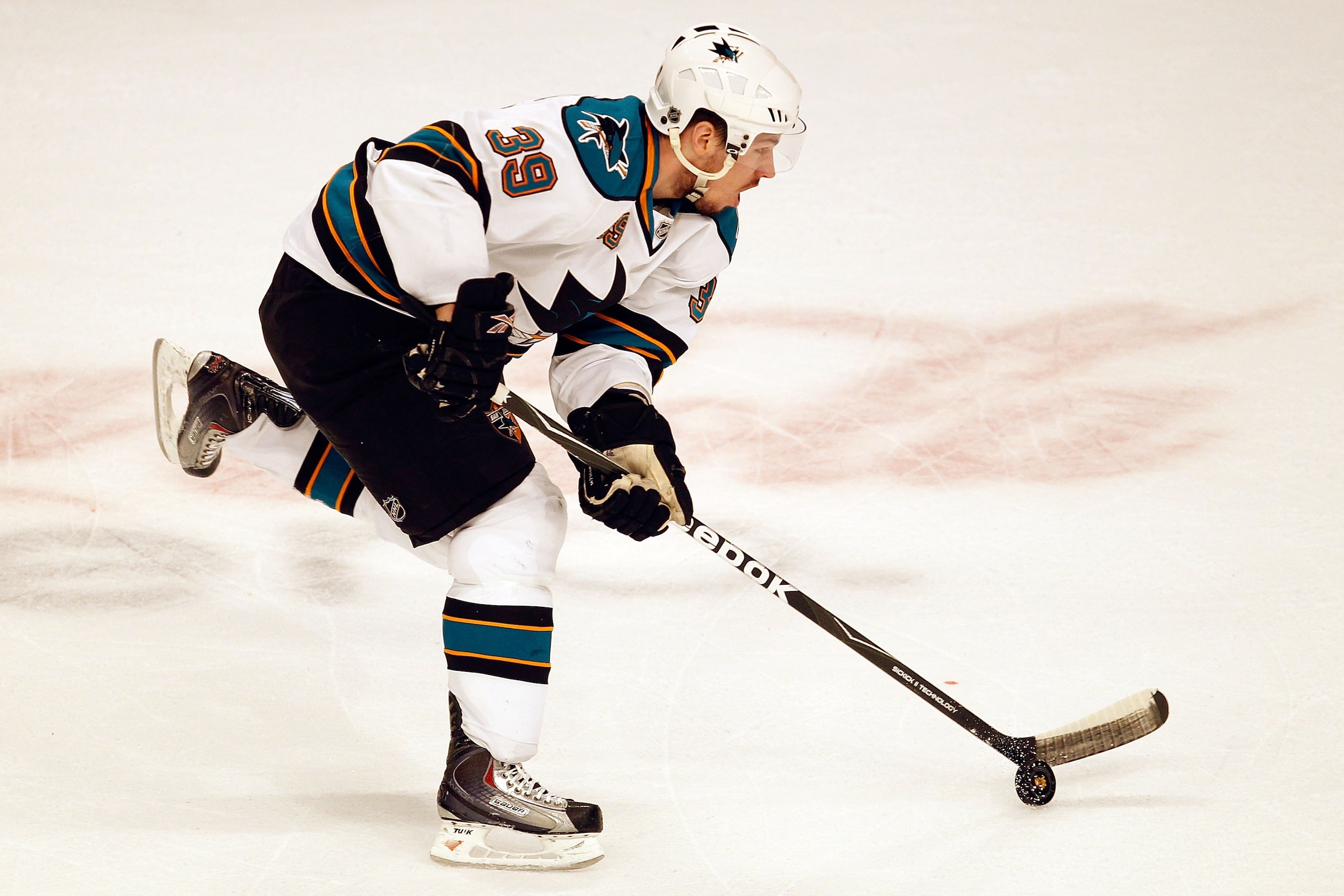 CHICAGO - MAY 21:  Logan Couture #39 of the San Jose Sharks moves the puck while taking on the Chicago Blackhawks in Game Three of the Western Conference Finals during the 2010 NHL Stanley Cup Playoffs at the United Center on May 21, 2010 in Chicago, Illi