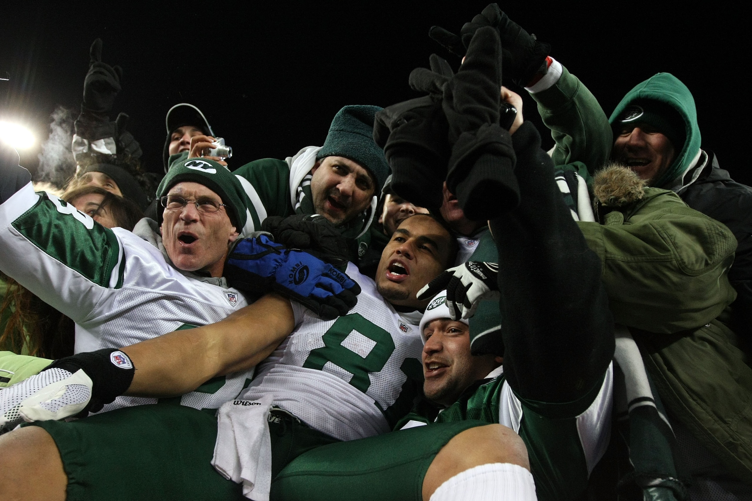 FOXBORO, MA - JANUARY 16:  Dustin Keller #81 of the New York Jets celebrates with fans after the Jets defeated the Patriots 28 to 21 in their 2011 AFC divisional playoff game at Gillette Stadium on January 16, 2011 in Foxboro, Massachusetts.  (Photo by Al