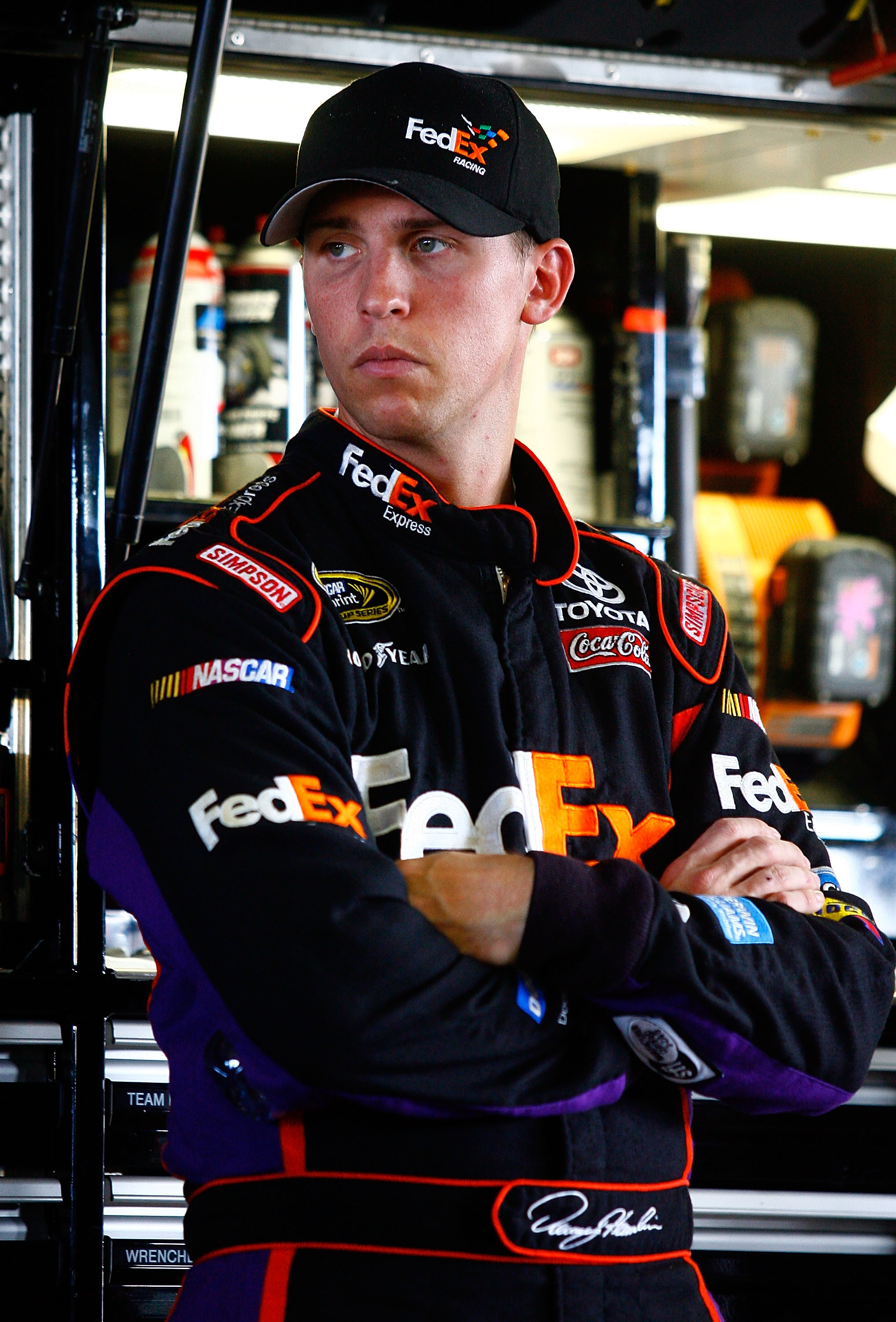HOMESTEAD, FL - NOVEMBER 19:  Denny Hamlin, driver of the #11 FedEx Toyota, stands in the garage during practice for the NASCAR Sprint Cup Series Ford 400 at Homestead-Miami Speedway on November 19, 2010 in Homestead, Florida.  (Photo by Jason Smith/Getty