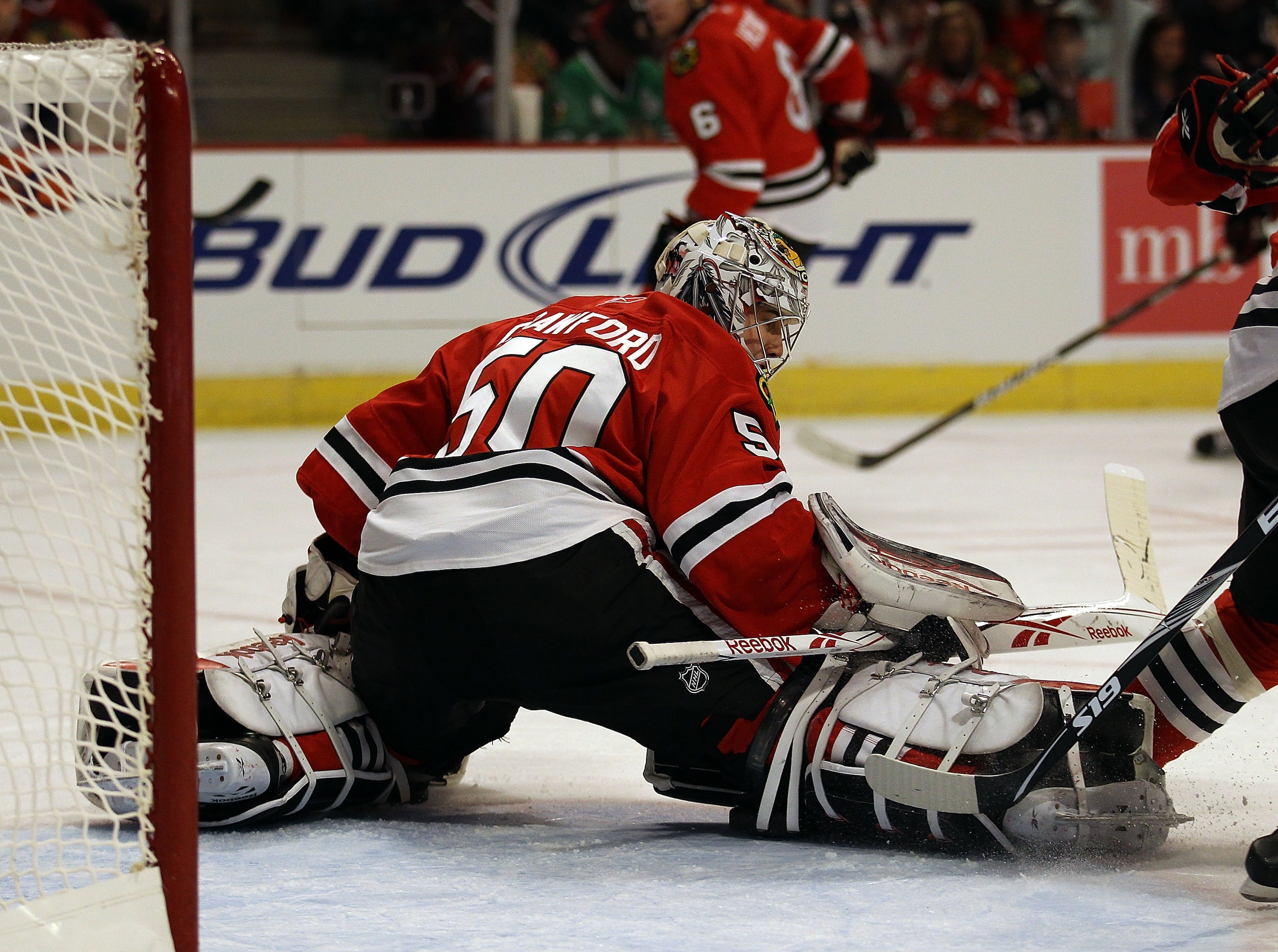 CHICAGO, IL - JANUARY 09: Corey Crawford #50 of the Chicago Blackhawks makes a save against the New York Islanders on his way to a shut-out win at the United Center on January 9, 2011 in Chicago, Illinois. The Blackhawks defeated the Islanders 5-0.  (Phot