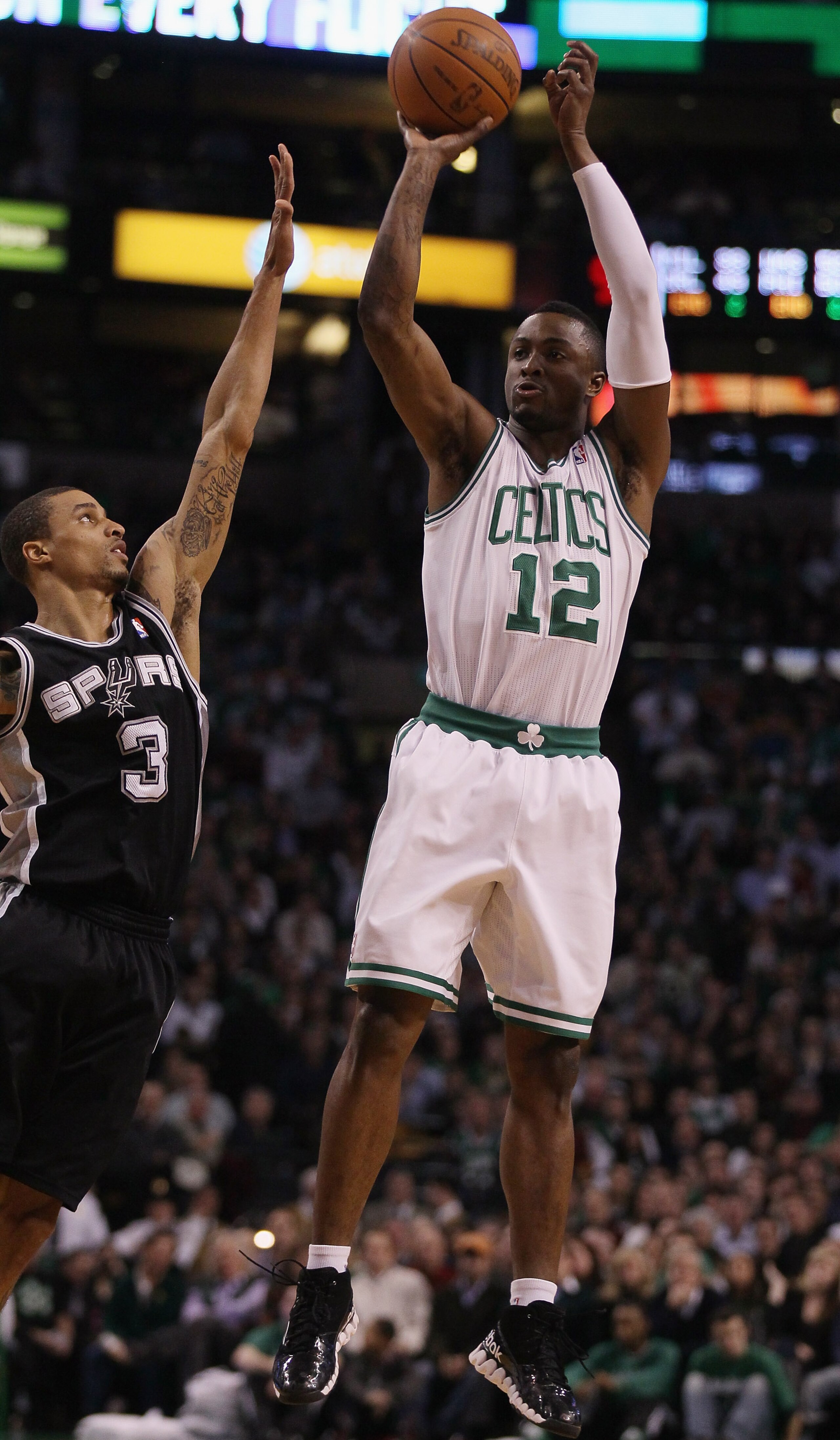 BOSTON, MA - JANUARY 05:  Von Wafer #12 of the Boston Celtics takes a shot as George Hill #3 of the San Antonio Spurs defends on January 5, 2011 at the TD Garden in Boston, Massachusetts. NOTE TO USER: User expressly acknowledges and agrees that, by downl