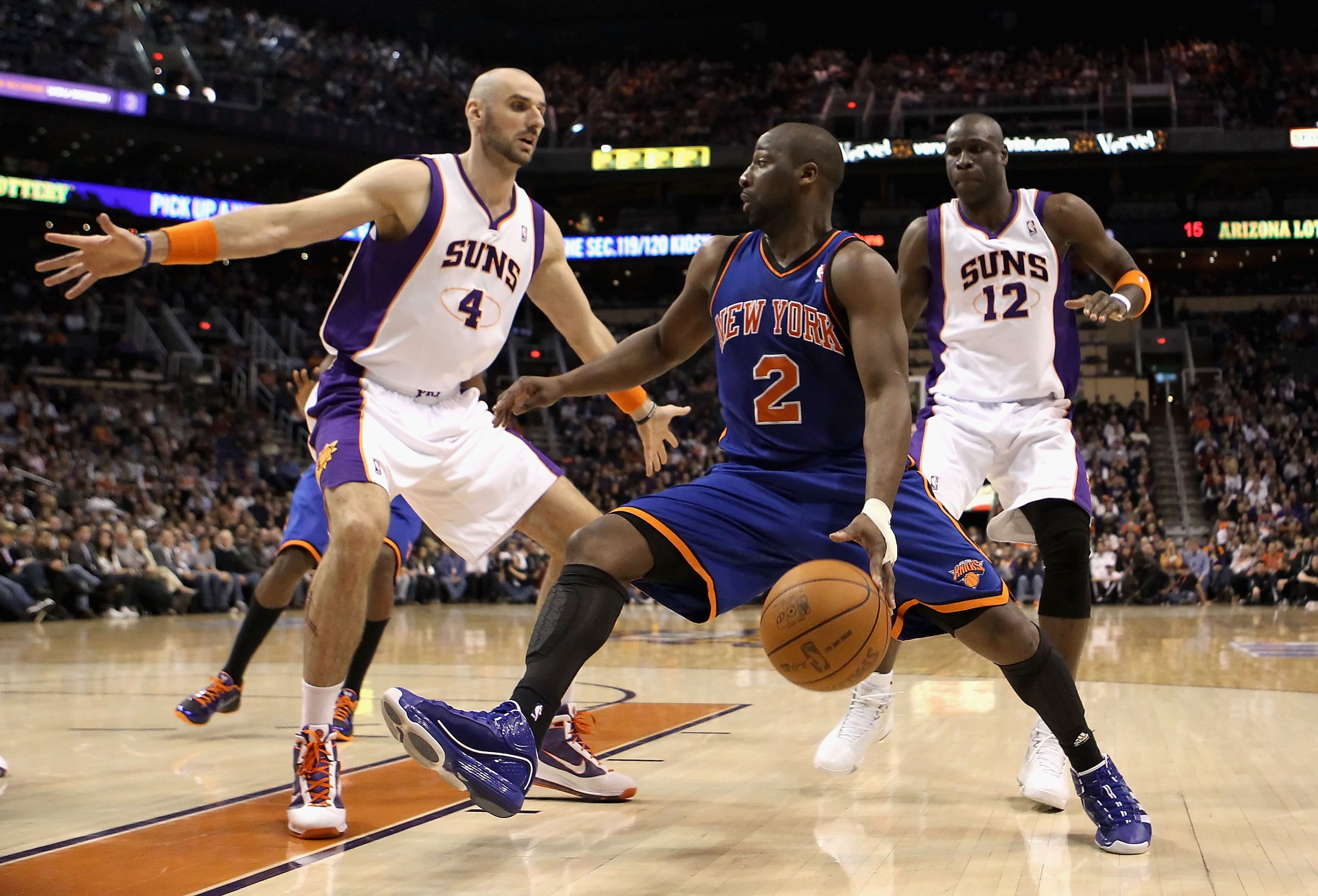 PHOENIX - JANUARY 07:  Raymond Felton #2 of the New York Knicks handles the ball under pressure from Marcin Gortat #4 and Mickael Pietrus #12 of the Phoenix Suns during the NBA game at US Airways Center on January 7, 2011 in Phoenix, Arizona. The Knicks d