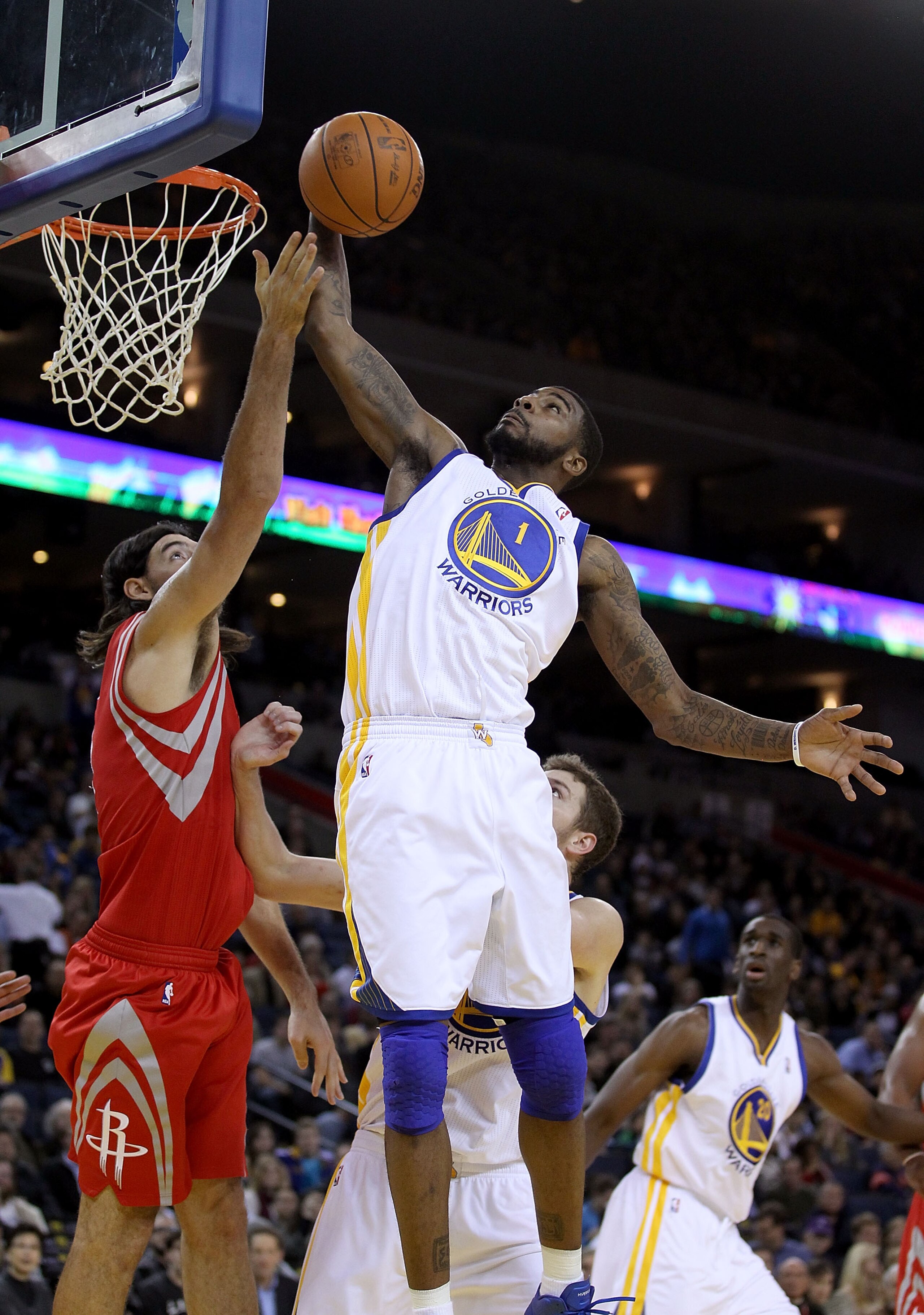 OAKLAND, CA - DECEMBER 20:  Dorell Wright #1 of the Golden State Warriors grabs a rebound over Luis Scola #4 of the Houston Rockets at Oracle Arena on December 20, 2010 in Oakland, California. NOTE TO USER: User expressly acknowledges and agrees that, by