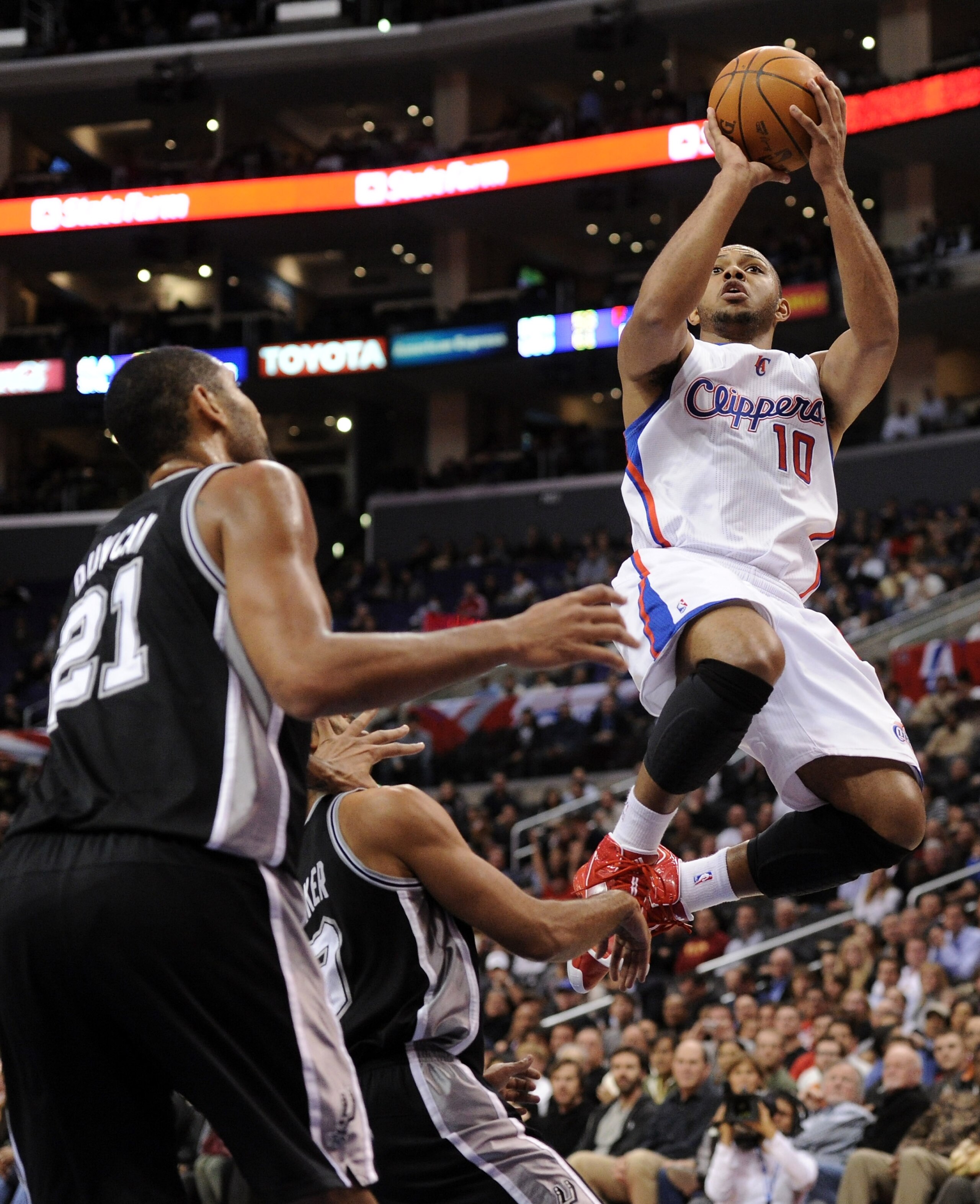 LOS ANGELES, CA - DECEMBER 01:  Eric Gordon #10 of the Los Angeles Clippers shoots a jumper over Tim Duncan #21 of the San Antonio Spurs at the Staples Center on December 1, 2010 in Los Angeles, California.  NOTE TO USER: User expressly acknowledges and a