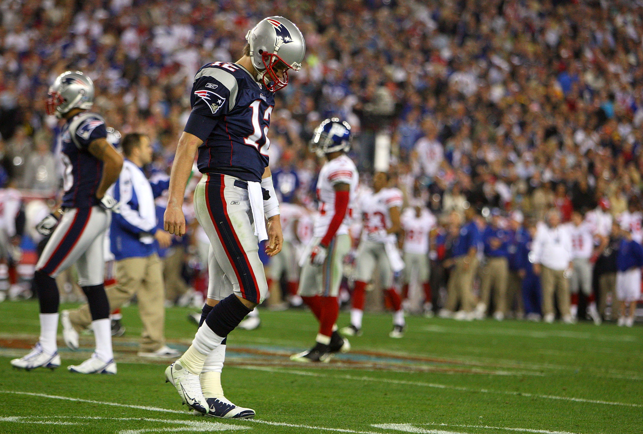 GLENDALE, AZ - FEBRUARY 03:  Quarterback Tom Brady #12 of the New England Patriots walks off the field after losing to the New York Giants 17-14 in Super Bowl XLII on February 3, 2008 at the University of Phoenix Stadium in Glendale, Arizona.  (Photo by D