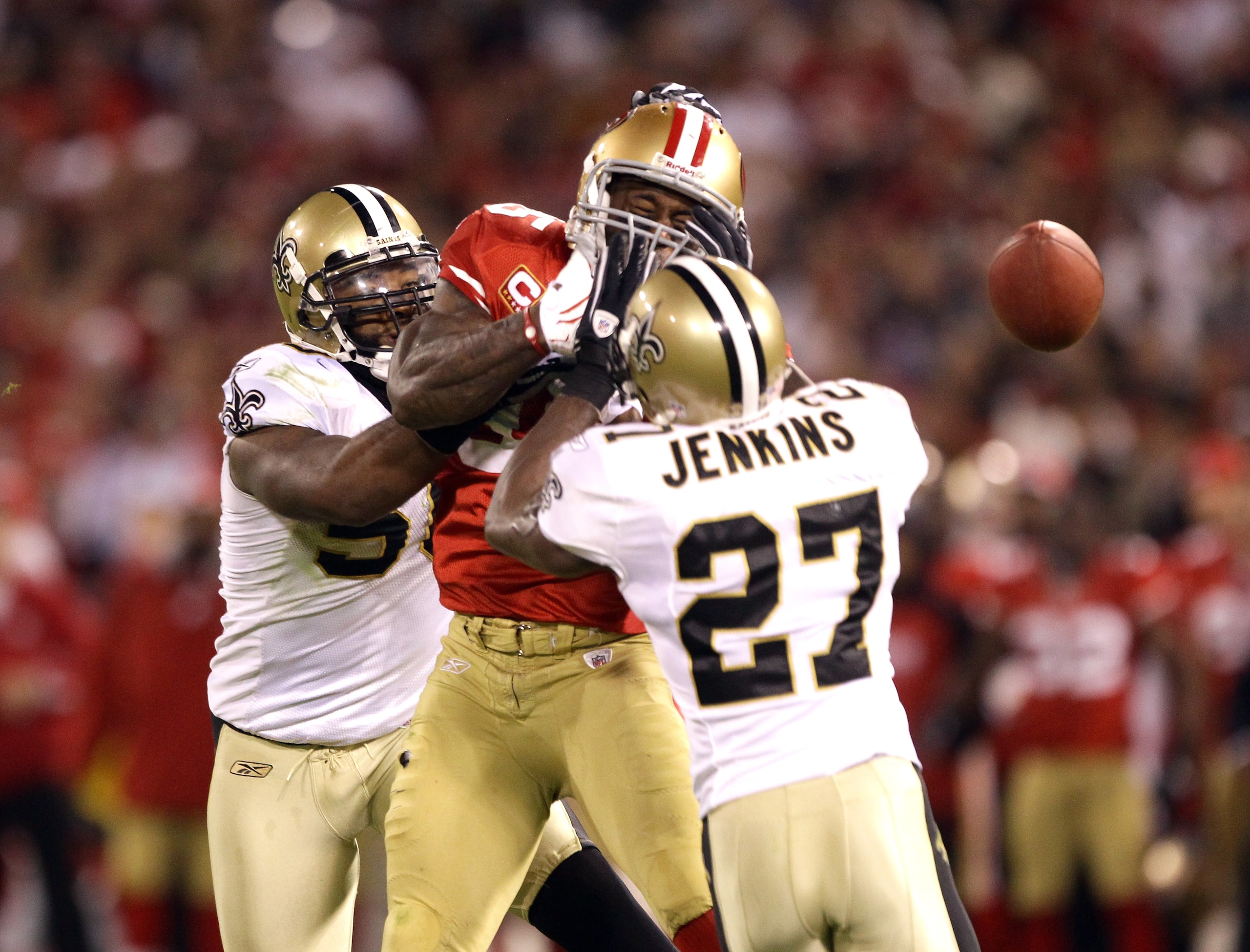 SAN FRANCISCO - SEPTEMBER 20: Vernon Davis #85 of the San Francisco 49ers loses the ball while defended by Malcolm Jenkins #27 and Marvin Mitchell #50 of the New Orleans Saints at Candlestick Park on September 20, 2010 in San Francisco, California. (Pho SAN FRANCISCO - SEPTEMBER 20: Vernon Davis #85 of the San Francisco 49ers loses the ball while defended by Malcolm Jenkins #27 and Marvin Mitchell #50 of the New Orleans Saints at Candlestick Park on September 20, 2010 in San Francisco, California. (Pho