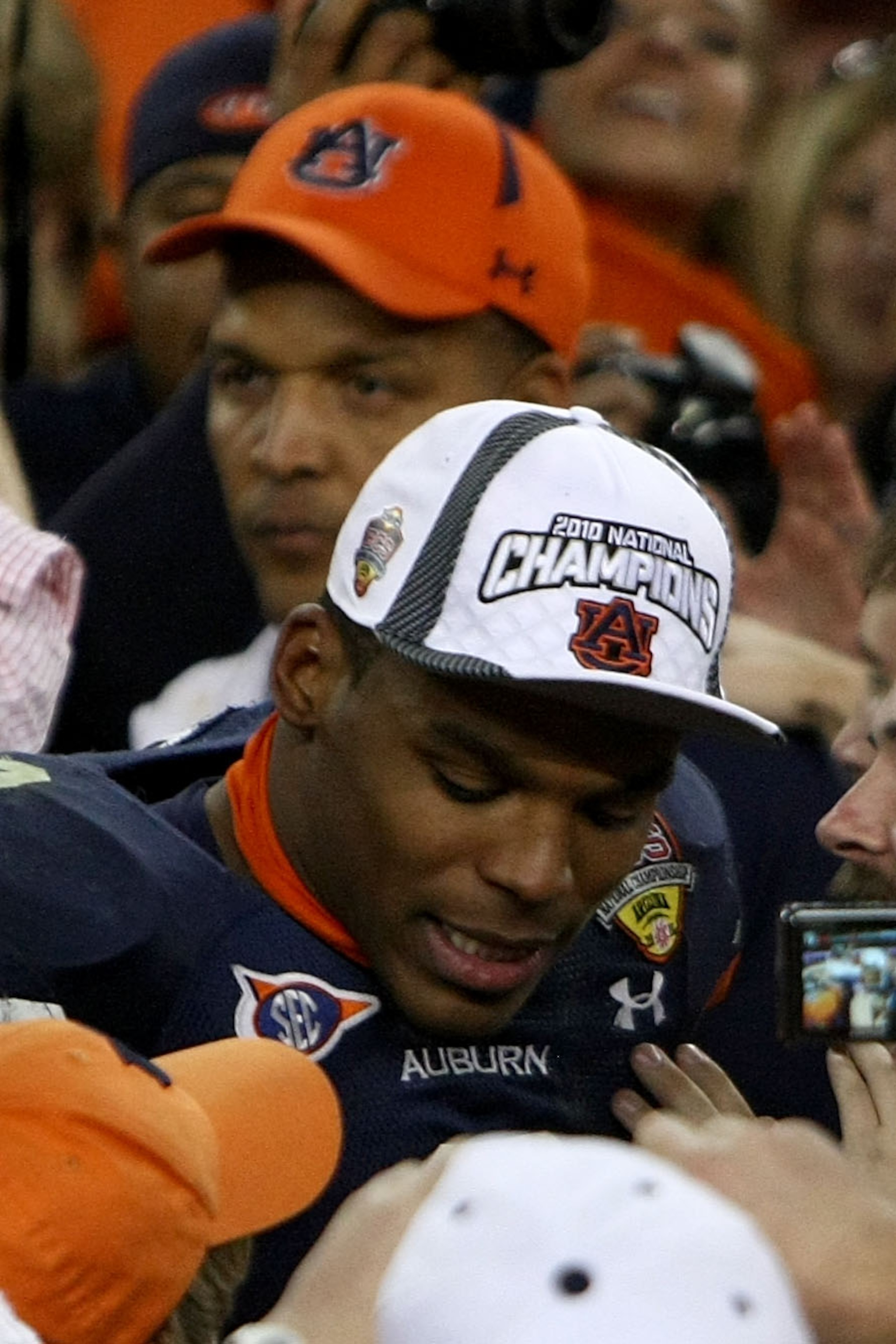 GLENDALE, AZ - JANUARY 10: Quarterback Cameron Newton #2 of the Auburn Tigers celebrates as his father Cecil Newton is behind him after the Tigers 22-19 victory against the Oregon Ducks in the Tostitos BCS National Championship Game at University of Phoe GLENDALE, AZ - JANUARY 10: Quarterback Cameron Newton #2 of the Auburn Tigers celebrates as his father Cecil Newton is behind him after the Tigers 22-19 victory against the Oregon Ducks in the Tostitos BCS National Championship Game at University of Phoe