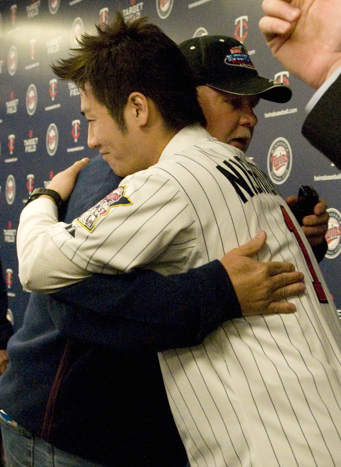 Minnesota Twins' Justin Morneau, right, hugs pitcher Joe Nathan as