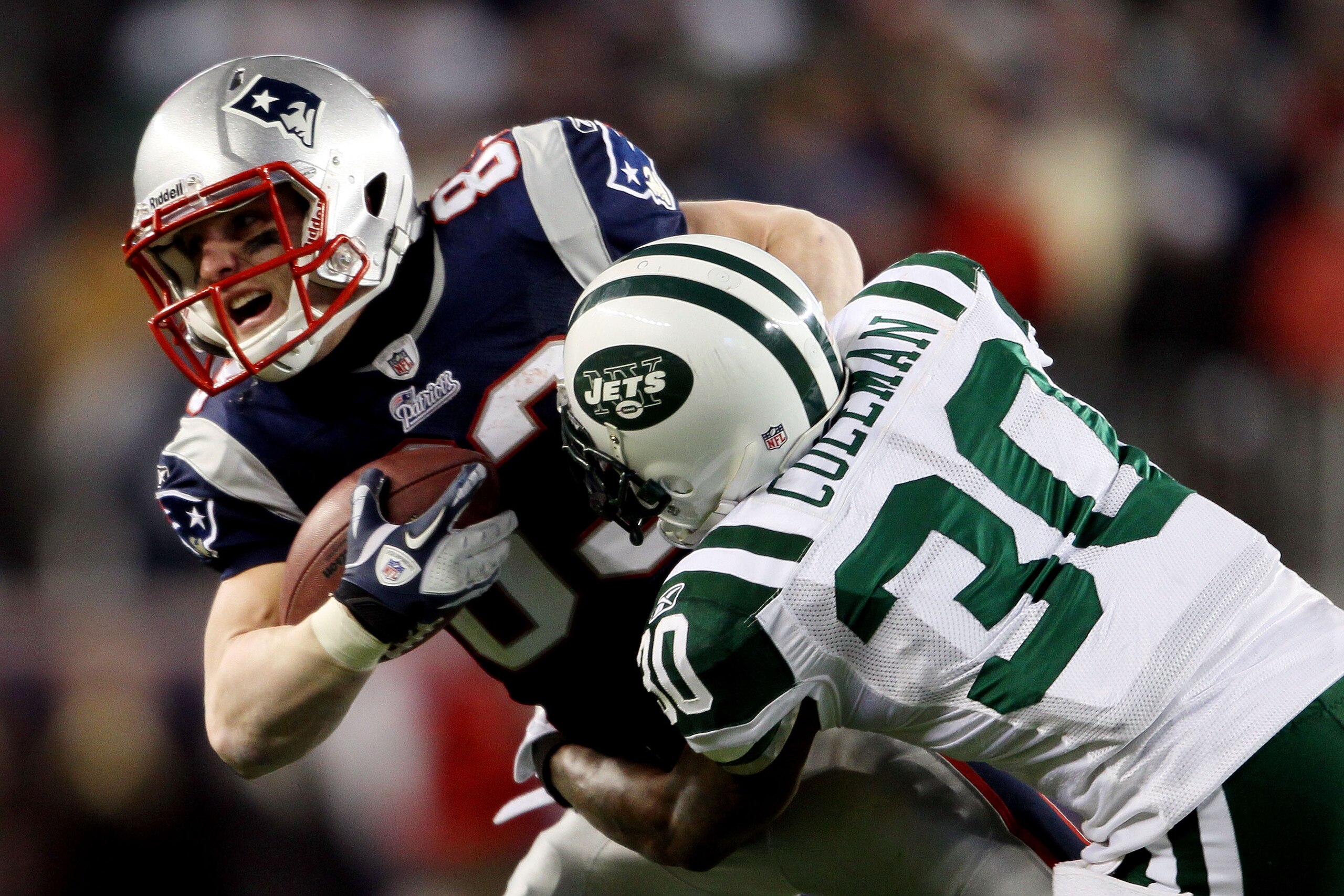 FOXBORO, MA - JANUARY 16:  Drew Coleman #30 of the New York Jets tackles Wes Welker #83 of the New England Patriots during their 2011 AFC divisional playoff game at Gillette Stadium on January 16, 2011 in Foxboro, Massachusetts.  (Photo by Elsa/Getty Imag