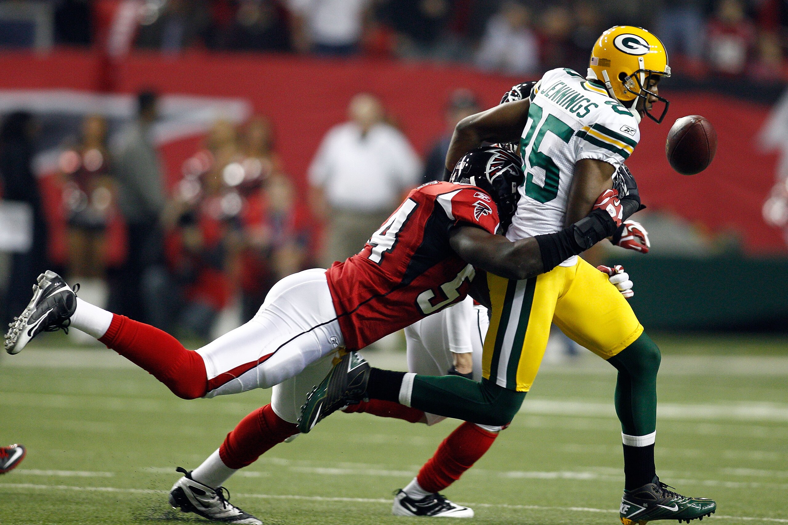 ATLANTA, GA - JANUARY 15:  Greg Jennings #85 of Green Bay Packers fumbles the ball in the first quarter against Stephen Nicholas #54 of the Atlanta Falcons during their 2011 NFC divisional playoff game at Georgia Dome on January 15, 2011 in Atlanta, Georg