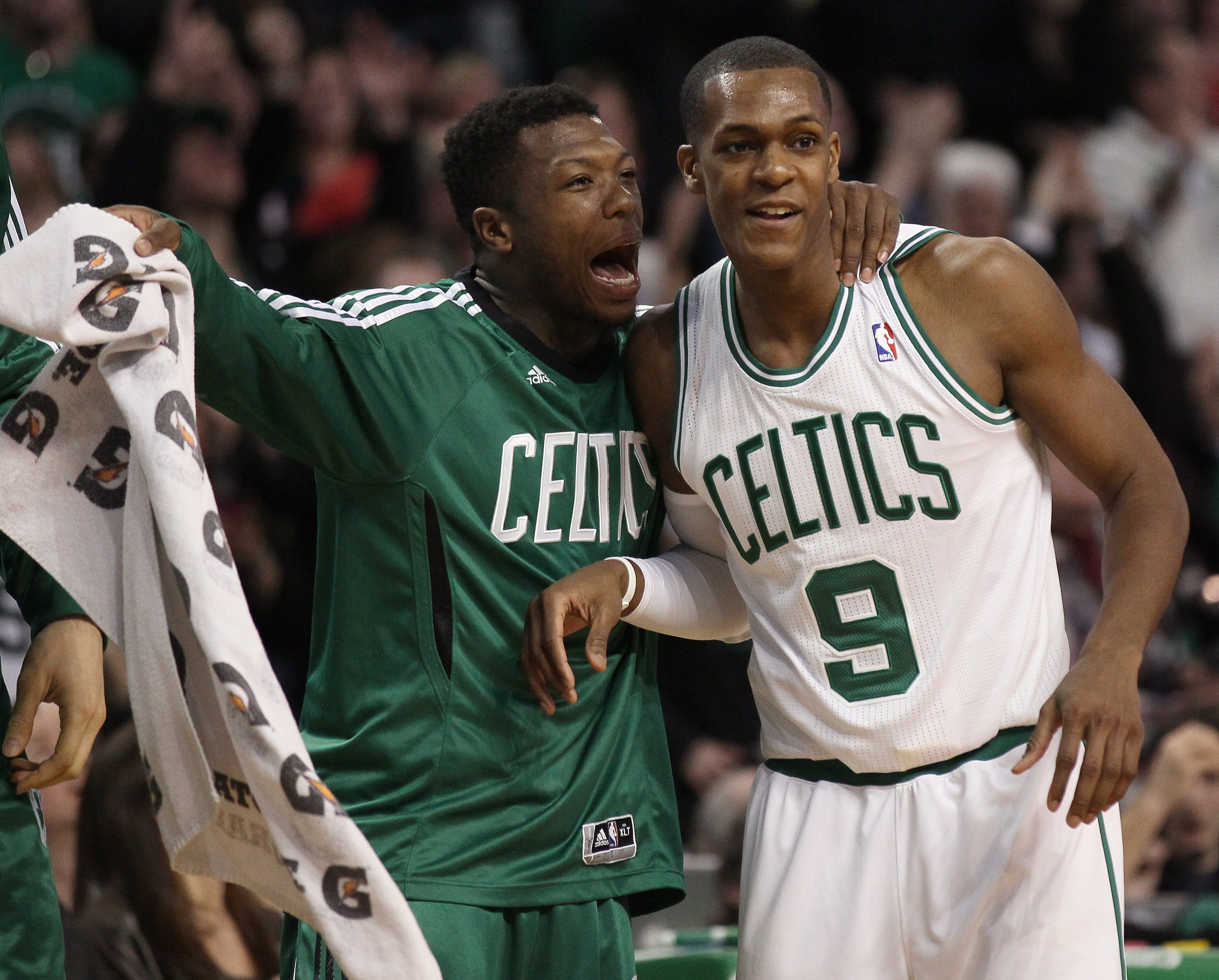 BOSTON, MA - JANUARY 03:  Rajon Rondo #9 of the Boston Celtics is congratulated by teammate Nate Robinson #4 in the fourth quarter againsts the Minnesota Timberwolves on January 3, 2011 at the TD Garden in Boston, Massachusetts. The Celtics defeated the T