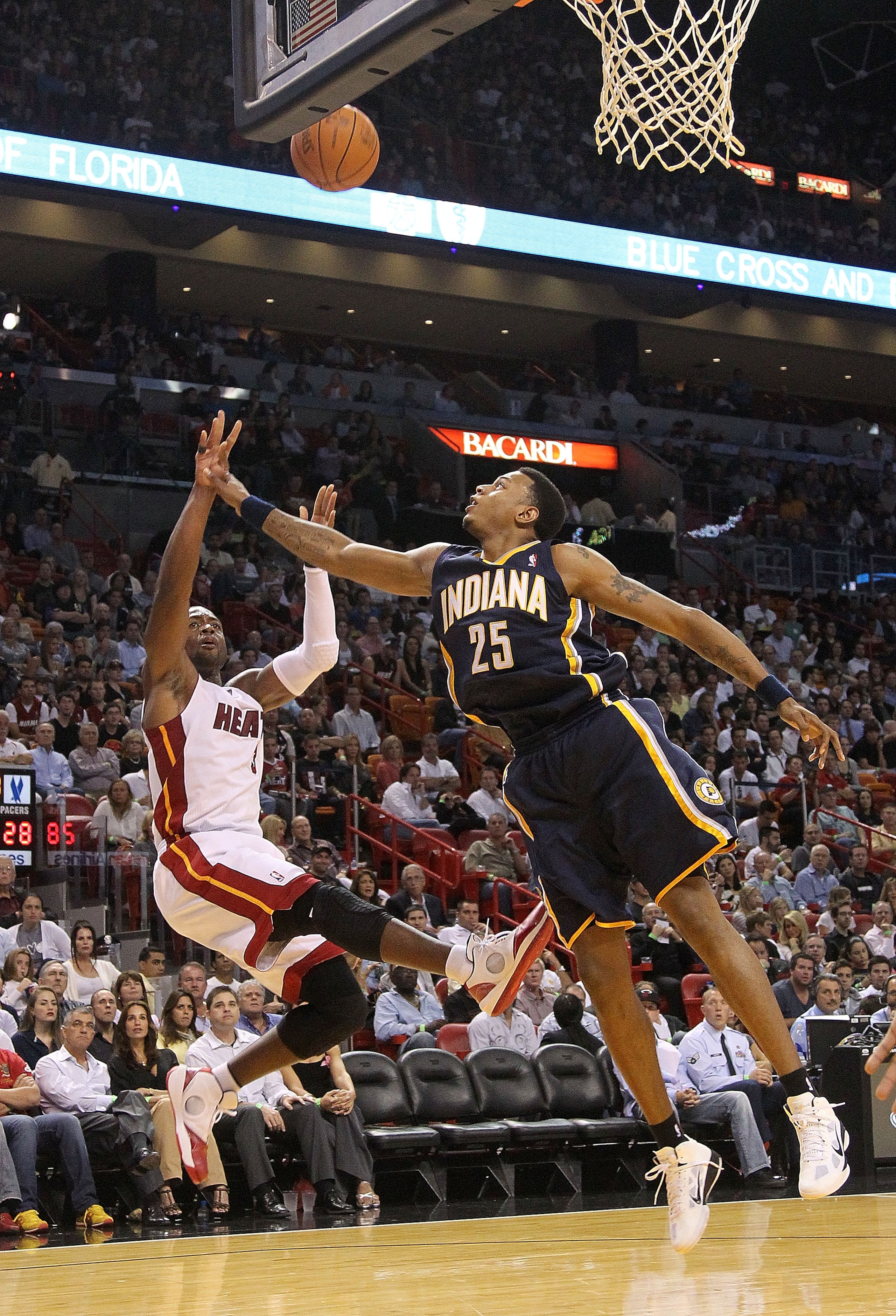 MIAMI - NOVEMBER 22:  Dwyane Wade #3 of the Miami Heat shoots over Brandon Rush #25 of the Indiana Pacers during a game at American Airlines Arena on November 22, 2010 in Miami, Florida. NOTE TO USER: User expressly acknowledges and agrees that, by downlo