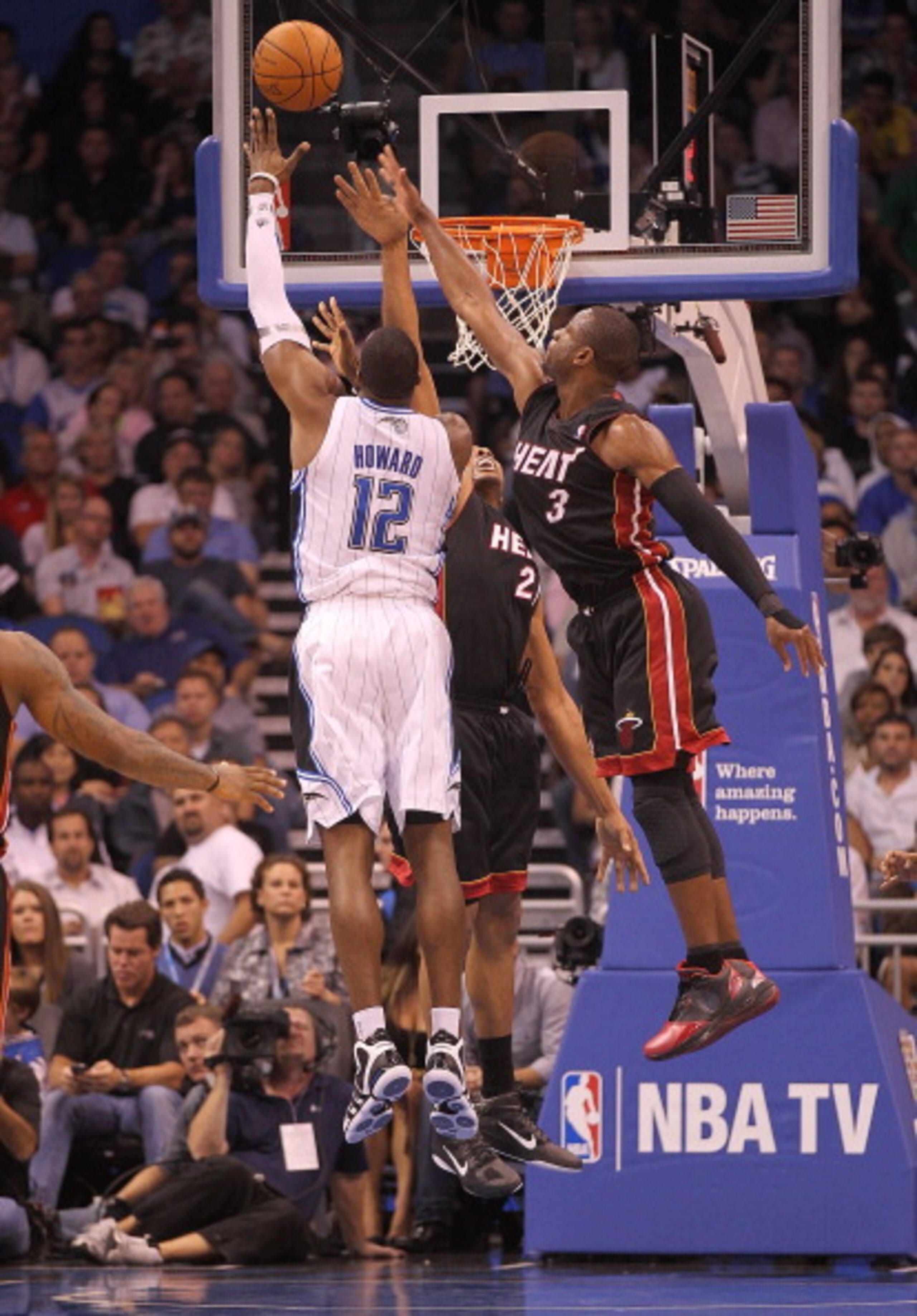 ORLANDO, FL - NOVEMBER 24: Dwight Howard #12 of the Orlando Magic shoots over Dwyane Wade #3 of the Miami Heat during a game at Amway Arena on November 24, 2010 in Orlando, Florida. NOTE TO USER: User expressly acknowledges and agrees that, by downloading