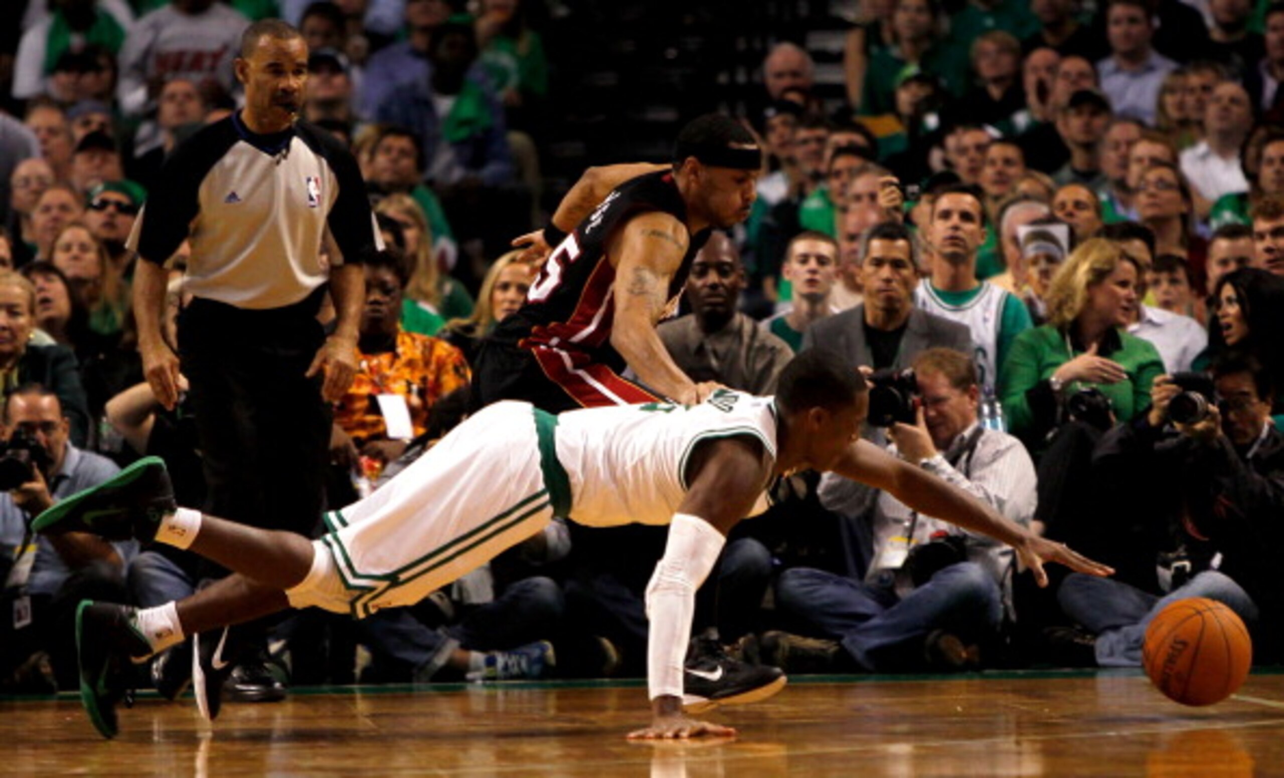 BOSTON, MA - OCTOBER 26: Eddie House #55 of the Miami Heat battles Rajon Rondo #9 of the Boston Celtics for a loose ball at the TD Banknorth Garden on October 26, 2010 in Boston, Massachusetts. NOTE TO USER: User expressly acknowledges and agrees that, by