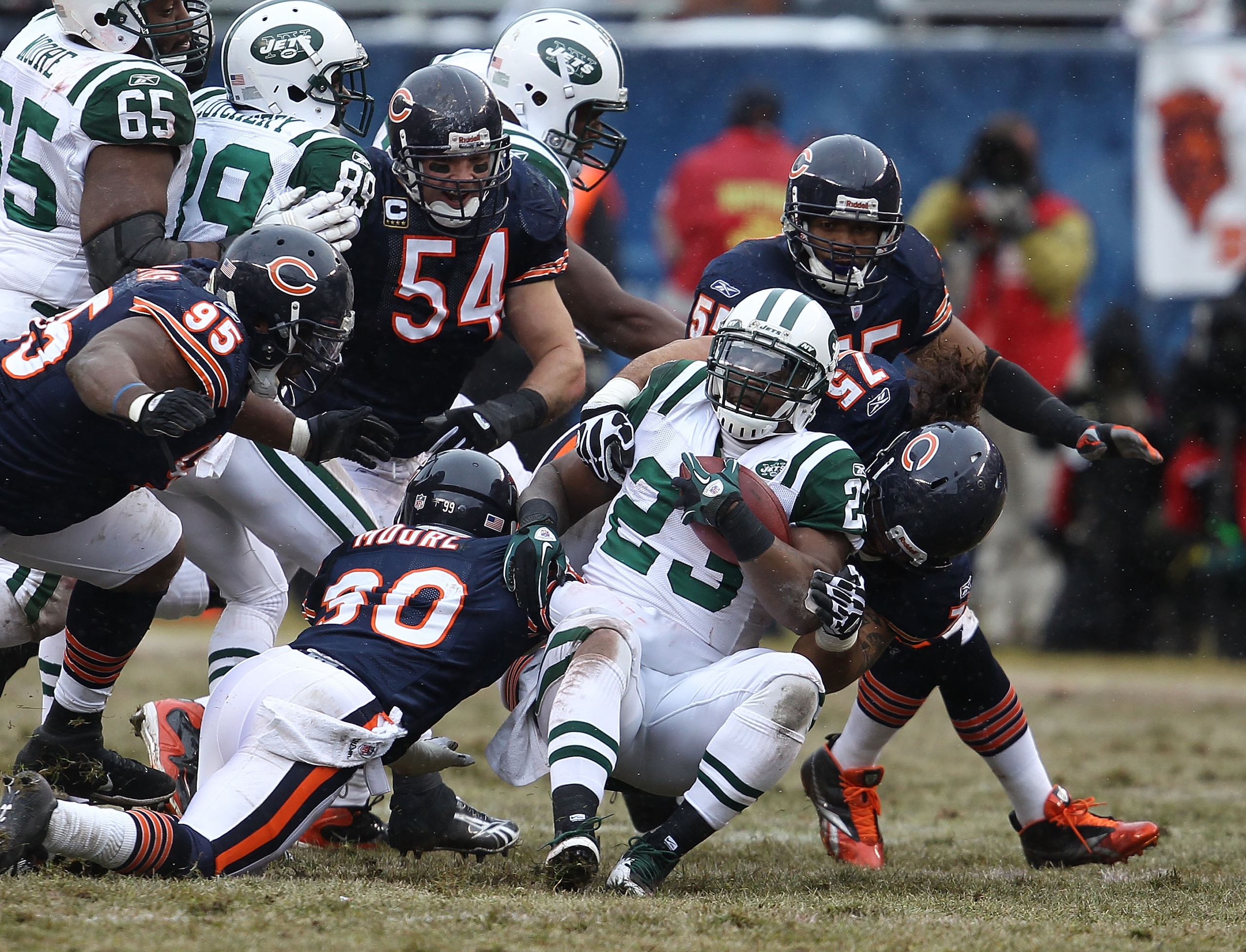 CHICAGO, IL - DECEMBER 26: Shonn Greene #23 of the New York Jets is tackled by D.J. Moore #30 and Matt Toeaina #75 of the Chicago Bears as Anthony Adams #95, Brian Urlacher #54 and Lance Briggs #55 close in at Soldier Field on December 26, 2010 in Chicago