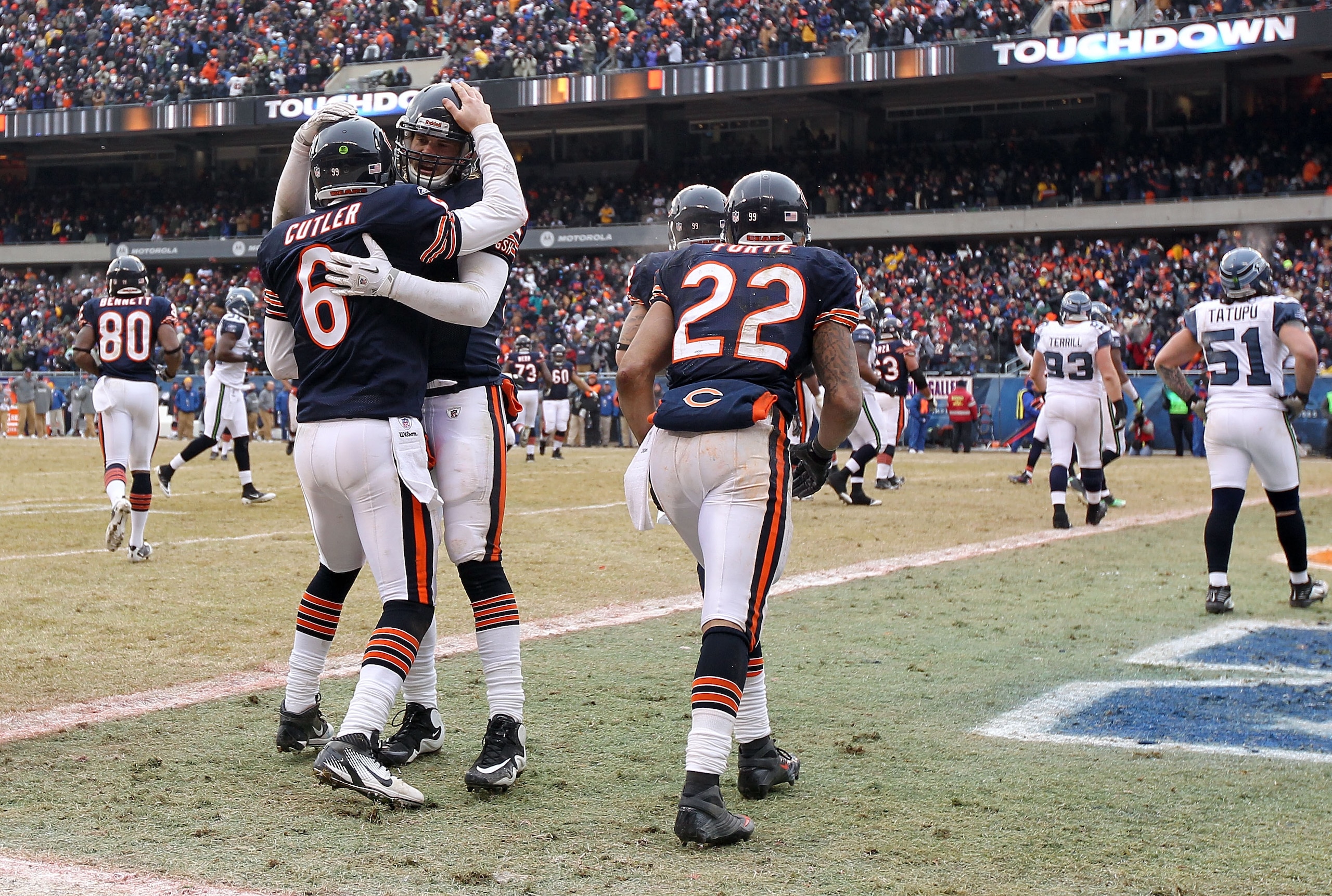 CHICAGO, IL - JANUARY 16: Quarterback Jay Cutler #6 of the Chicago Bears celebrates with teammate Greg Olsen #82 after Cutler scores on a nine-yard touchdown run in the third quarter against the Seattle Seahawks in the 2011 NFC divisional playoff game at CHICAGO, IL - JANUARY 16: Quarterback Jay Cutler #6 of the Chicago Bears celebrates with teammate Greg Olsen #82 after Cutler scores on a nine-yard touchdown run in the third quarter against the Seattle Seahawks in the 2011 NFC divisional playoff game at