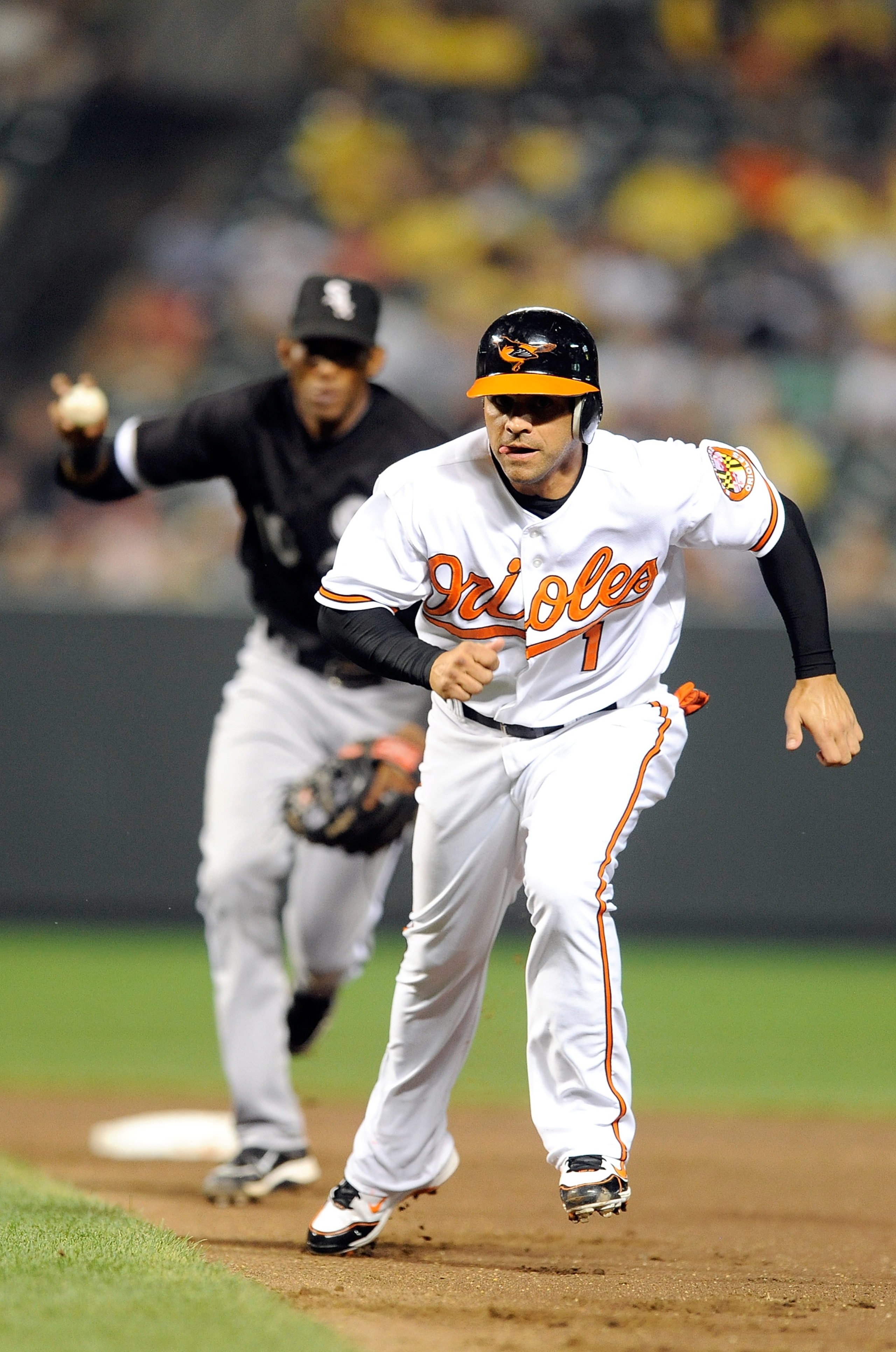 BALTIMORE - AUGUST 09: Brian Roberts #1 of the Baltimore Orioles is caught in a run-down and tagged out by Alexei Ramirez #10 of the Chicago White Sox at Camden Yards on August 9, 2010 in Baltimore, Maryland. The Orioles won the game 3-2. (Photo by Greg BALTIMORE - AUGUST 09: Brian Roberts #1 of the Baltimore Orioles is caught in a run-down and tagged out by Alexei Ramirez #10 of the Chicago White Sox at Camden Yards on August 9, 2010 in Baltimore, Maryland. The Orioles won the game 3-2. (Photo by Greg