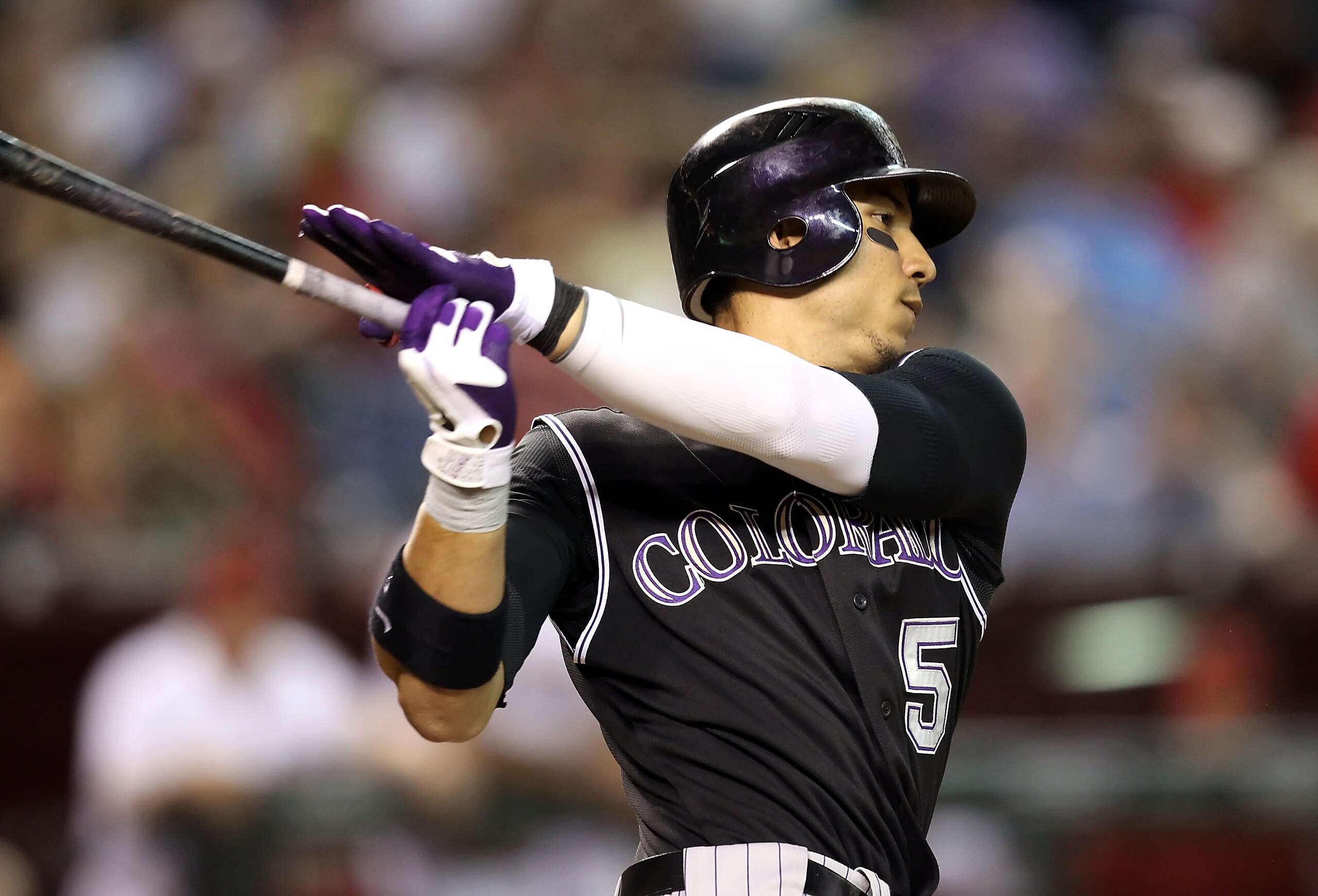 PHOENIX - SEPTEMBER 21:  Carlos Gonzalez #5 of the Colorado Rockies bats against the Arizona Diamondbacks during the Major League Baseball game at Chase Field on September 21, 2010 in Phoenix, Arizona.  (Photo by Christian Petersen/Getty Images)
