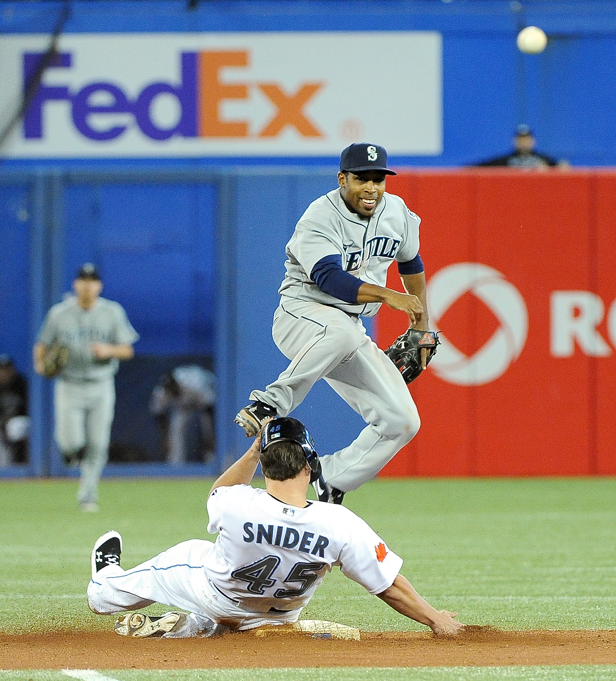 TORONTO, ON - SEPTEMBER 22: Chone Figgins #9 of the Seattle Mariners throws the ball to first base for a double play while Travis Snider #45 of the Toronto Blue Jays slides into second base on September 22, 2010 at the Rogers Centre in Toronto, Canada. ( TORONTO, ON - SEPTEMBER 22: Chone Figgins #9 of the Seattle Mariners throws the ball to first base for a double play while Travis Snider #45 of the Toronto Blue Jays slides into second base on September 22, 2010 at the Rogers Centre in Toronto, Canada. (