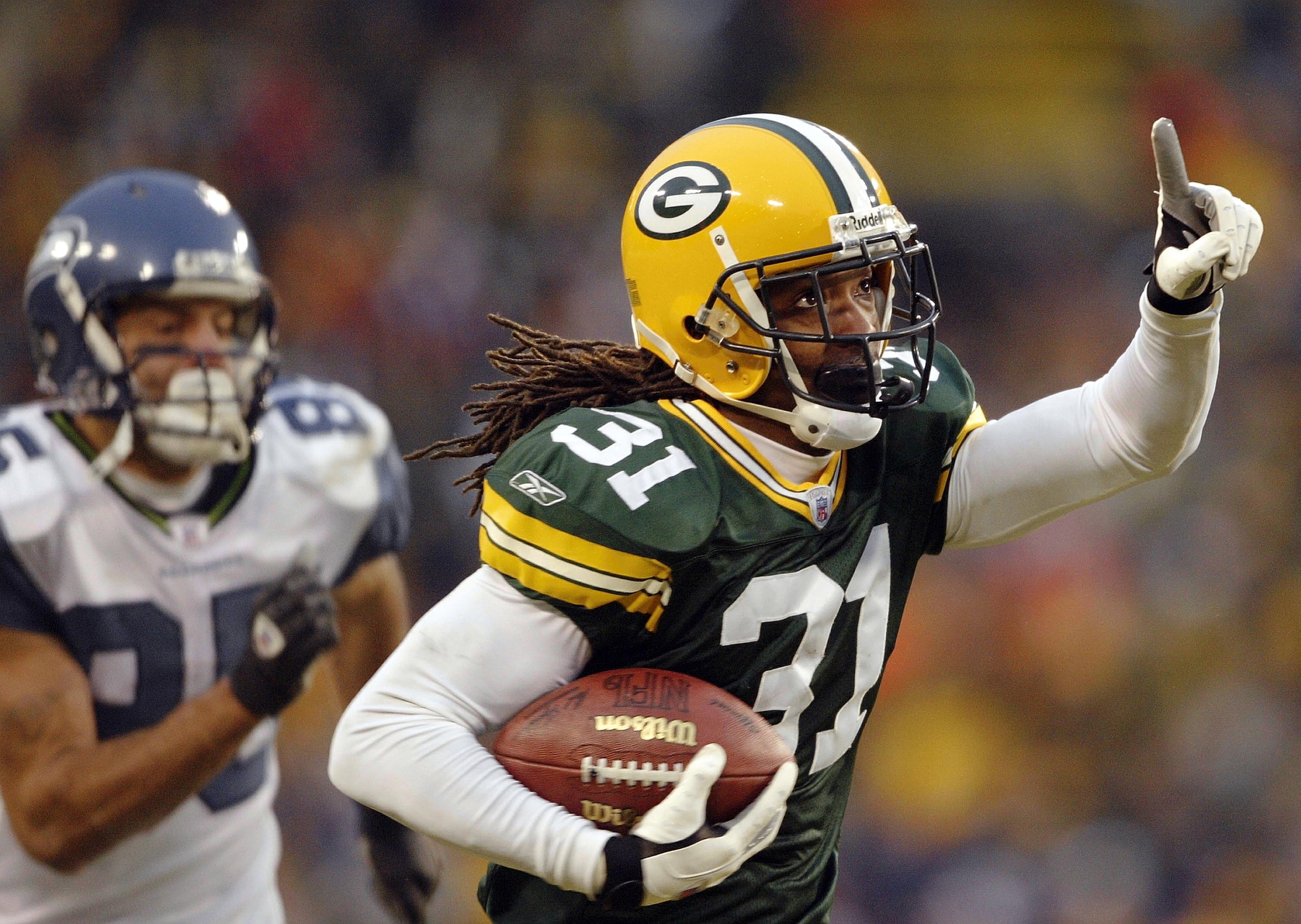 GREEN BAY, WI - JANUARY 4: Al Harris#31 of the Green Bay Packers intercepts a pass and runs it in for the game-winning touchdown in overtime against the Seattle Seahawks on January 4, 2004 at Lambeau Field in Green Bay, Wisconsin. The Packers defeated th GREEN BAY, WI - JANUARY 4: Al Harris#31 of the Green Bay Packers intercepts a pass and runs it in for the game-winning touchdown in overtime against the Seattle Seahawks on January 4, 2004 at Lambeau Field in Green Bay, Wisconsin. The Packers defeated th