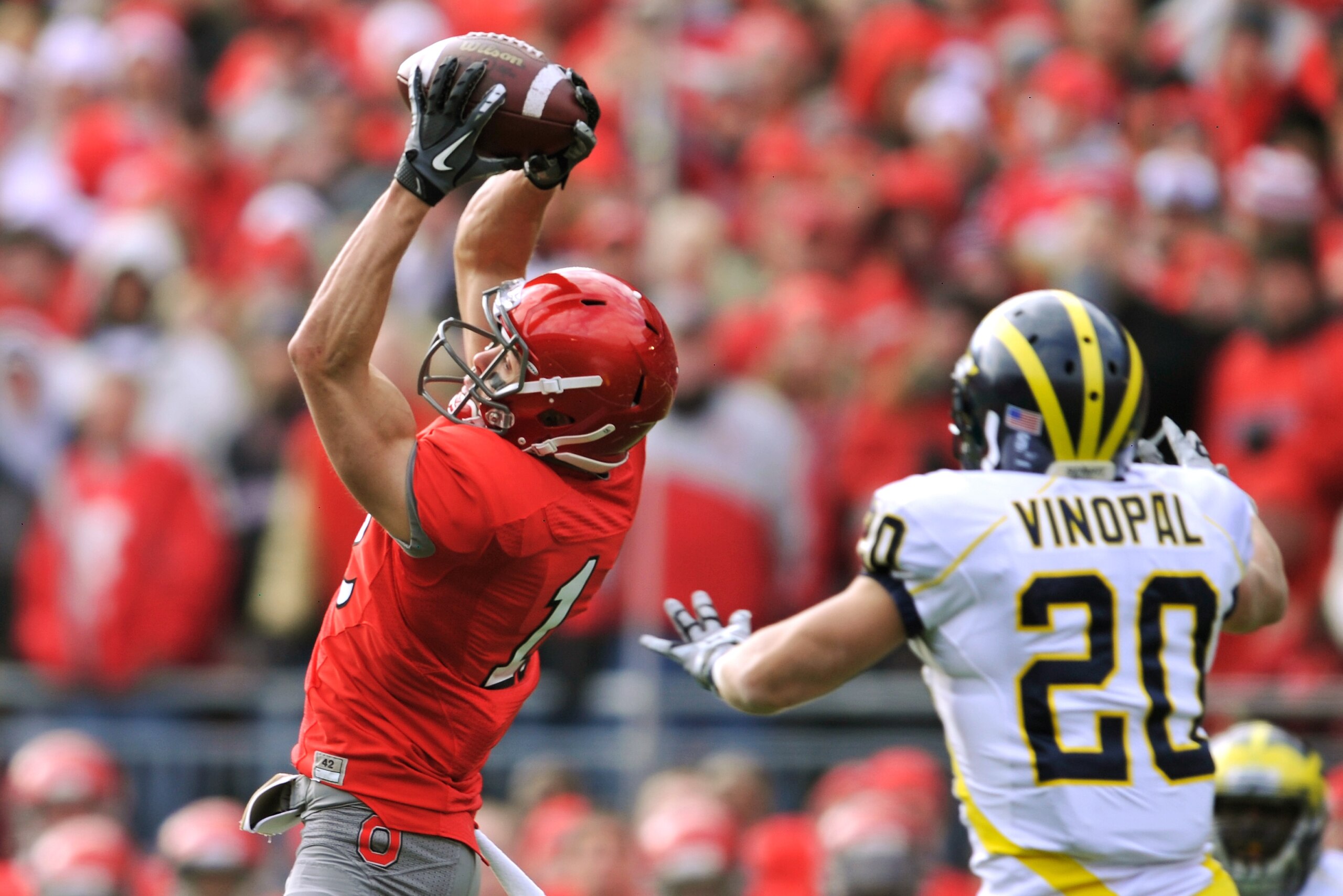 COLUMBUS, OH - NOVEMBER 27: Dane Sanzenbacher #12 of the Ohio State Buckeyes catches a pass for a first down in front of Ray Vinopal #20 of the Michigan Wolverines at Ohio Stadium on November 27, 2010 in Columbus, Ohio. (Photo by Jamie Sabau/Getty Image COLUMBUS, OH - NOVEMBER 27: Dane Sanzenbacher #12 of the Ohio State Buckeyes catches a pass for a first down in front of Ray Vinopal #20 of the Michigan Wolverines at Ohio Stadium on November 27, 2010 in Columbus, Ohio. (Photo by Jamie Sabau/Getty Image