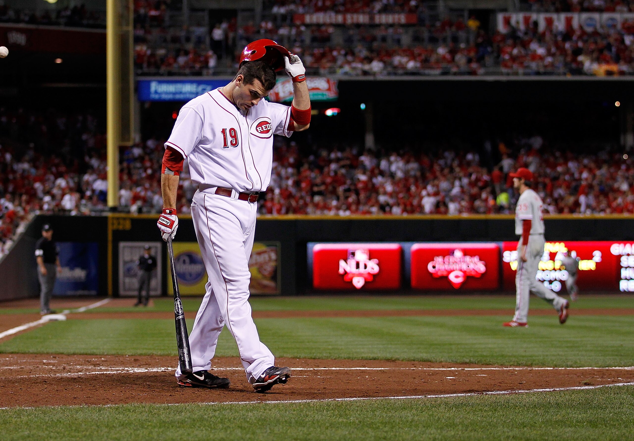 CINCINNATTI - OCTOBER 10: Joey Votto #19 of the Cincinnati Reds walks back to the dugout after striking out against Cole Hamels #35 of the Philadelpia Phillies, who also walks to the dugout, during game 3 of the NLDS at Great American Ball Park on October CINCINNATTI - OCTOBER 10: Joey Votto #19 of the Cincinnati Reds walks back to the dugout after striking out against Cole Hamels #35 of the Philadelpia Phillies, who also walks to the dugout, during game 3 of the NLDS at Great American Ball Park on October