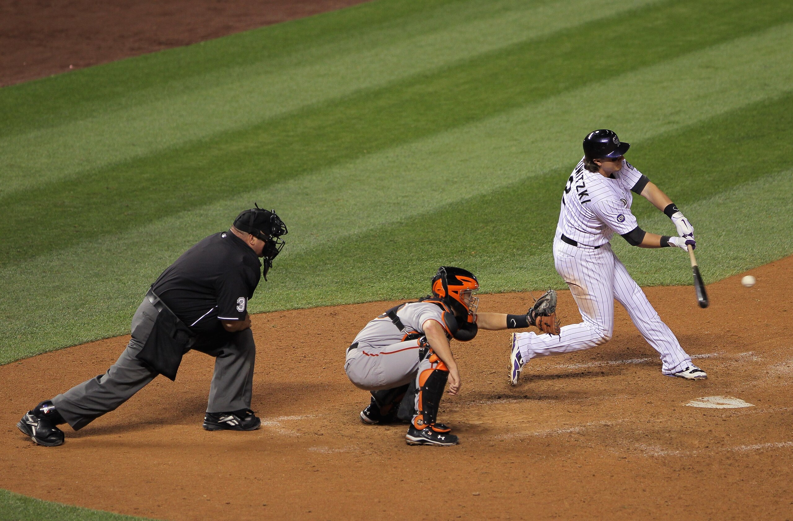 DENVER - SEPTEMBER 25:  Troy Tulowitzki #2 of the Colorado Rockies doubles to right field to score Clint Barmes and Dexter Fowler to tie the score 9-9 with the San Francisco Giants in the eighth inning at Coors Field on September 25, 2010 in Denver, Color