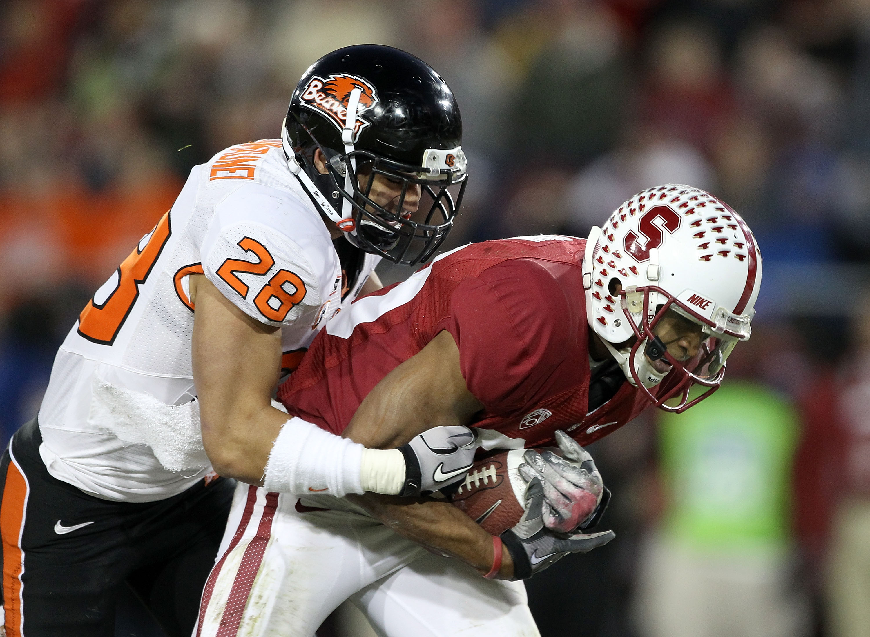 PALO ALTO, CA - NOVEMBER 27:  Doug Baldwin #89 of the Stanford Cardinal goes in for a 42-yard touchdown reception while Suaesi Tuimanunei #28 of the Oregon State Beavers tries to tackled him at Stanford Stadium on November 27, 2010 in Palo Alto, Californi