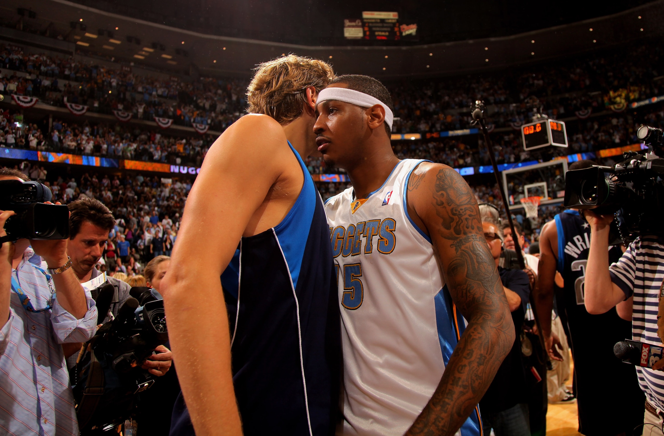 DENVER - MAY 13:  Carmelo Anthony #15 of the Denver Nuggets and Dirk Nowitzki #41 of the Dallas Mavericks exchange words on the court after Game Five of the Western Conference Semifinals during the 2009 NBA Playoffs at Pepsi Center on May 13, 2009 in Denv