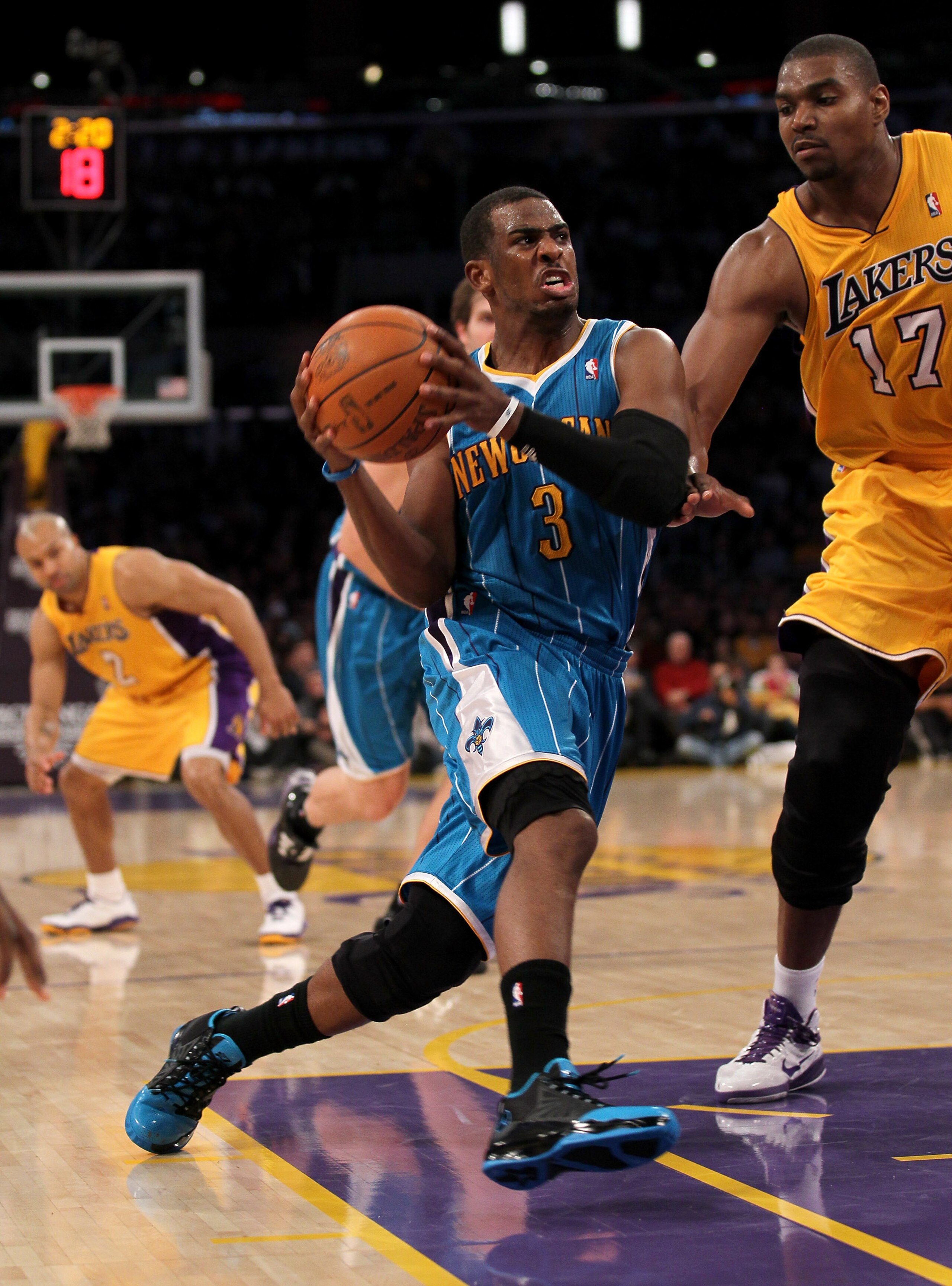 LOS ANGELES, CA - JANUARY 7:  Chris Paul #3 of the New Orleans Hornets drives against Andrew Bynum #17 of the Los Angeles Lakers at Staples Center on January 7, 2011 in Los Angeles, California.  NOTE TO USER: User expressly acknowledges and agrees that, b