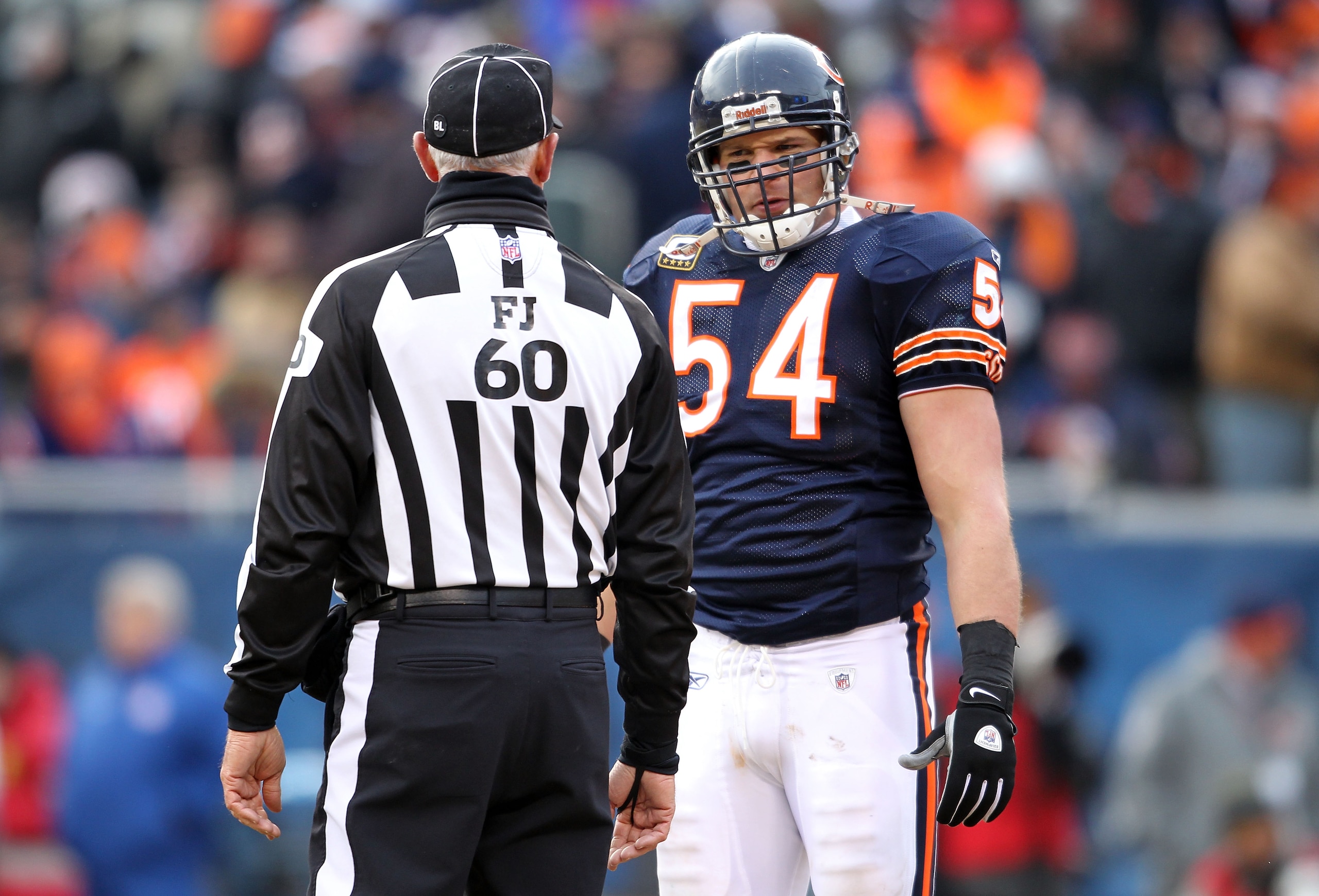 CHICAGO, IL - JANUARY 16:  Linebacker Brian Urlacher #54 of the Chicago Bears stares at field judge Gary Cavaletto #60 in the second half against the Seattle Seahawks in the 2011 NFC divisional playoff game at Soldier Field on January 16, 2011 in Chicago,