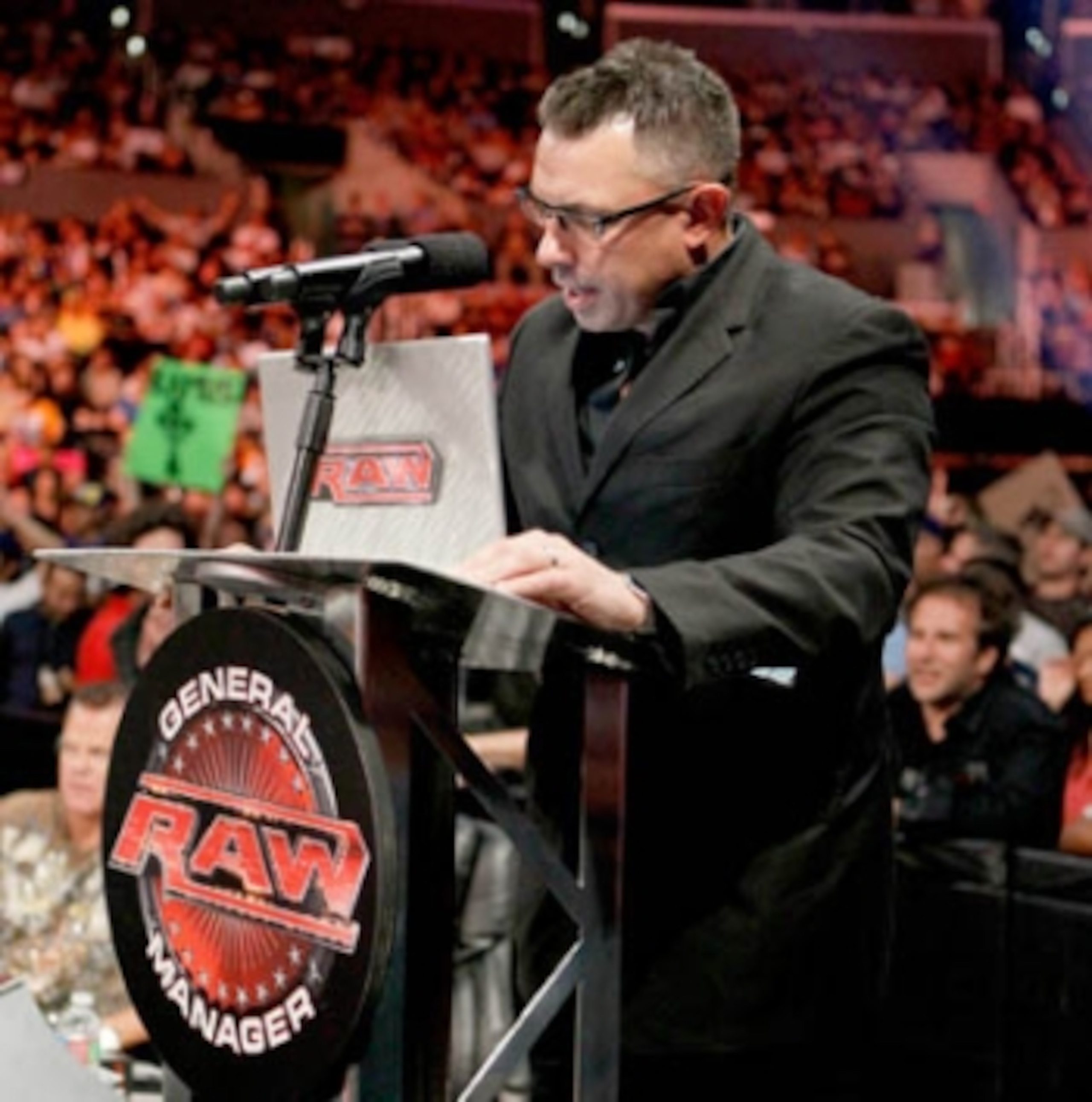 Michael Cole reading an email from the anonymous RAW GM, photo copyright to WWE.com