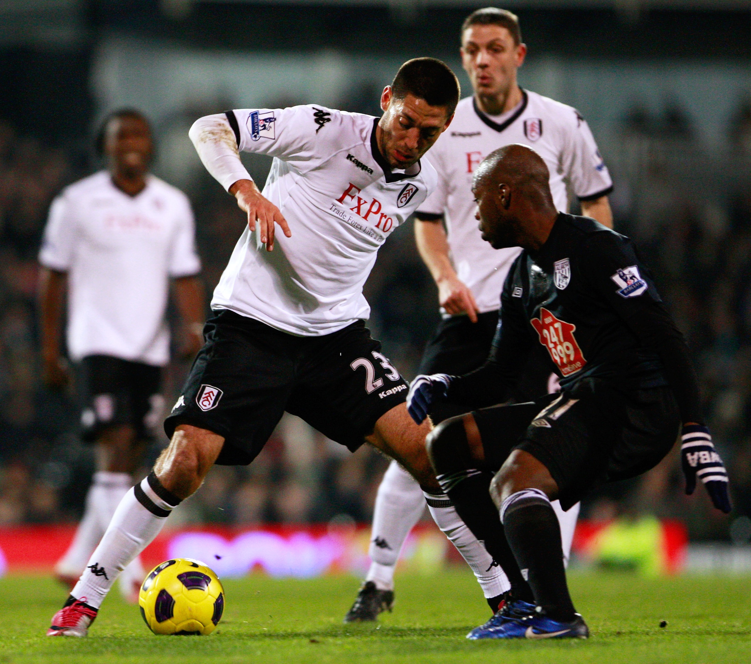 LONDON, ENGLAND - JANUARY 04:  Clint Dempsey (L) of Fulham battles for the ball with Youssouf Mulumbu of West Bromwich Albion during the Barclays Premier League match between Fulham and West Bromwich Albion at Craven Cottage on January 4, 2011 in London,