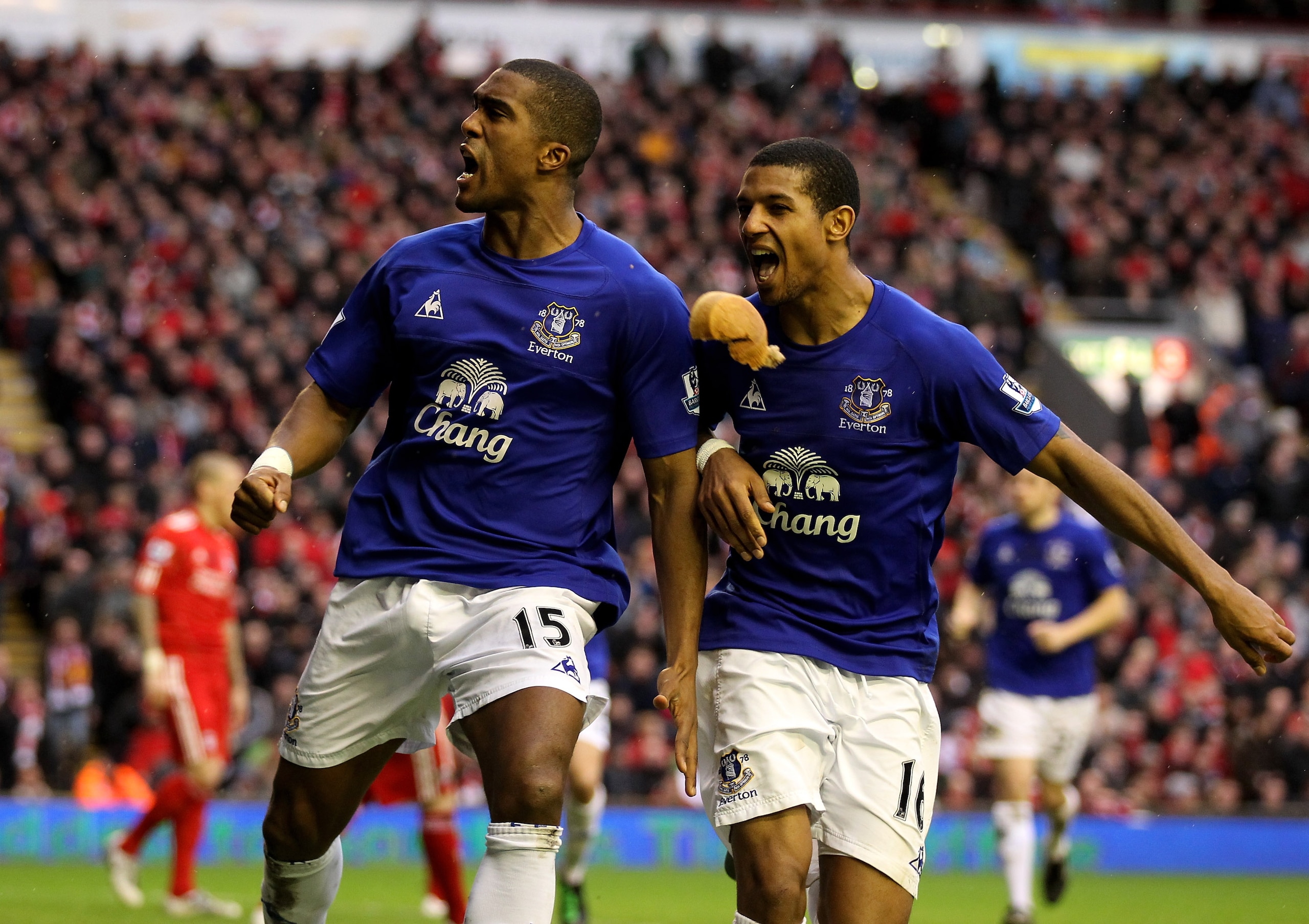 LIVERPOOL, ENGLAND - JANUARY 16:  Sylvain Distin of Everton celebrates scoring his team's first goal with team mate Jermaine Beckford (R) as a pie from the crowd flies towards them during the Barclays Premier League match between Liverpool and Everton at