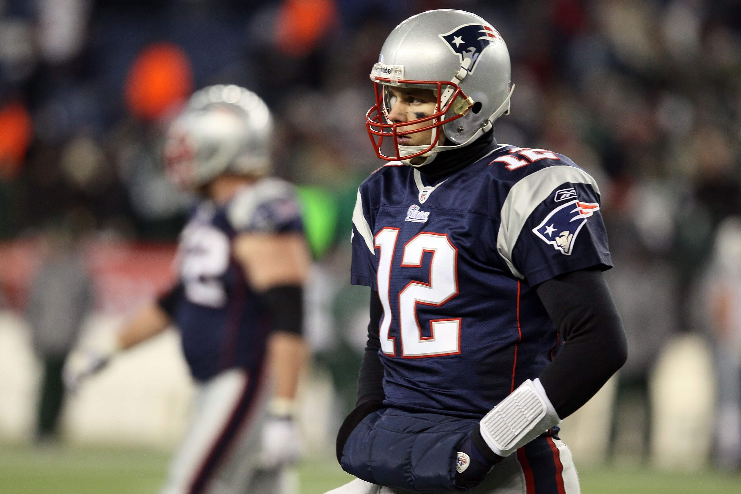 FOXBORO, MA - JANUARY 16:  Tom Brady #12 of the New England Patriots looks on near the end of their 28 to 21 loss to the New York Jets in their 2011 AFC divisional playoff game at Gillette Stadium on January 16, 2011 in Foxboro, Massachusetts.  (Photo by