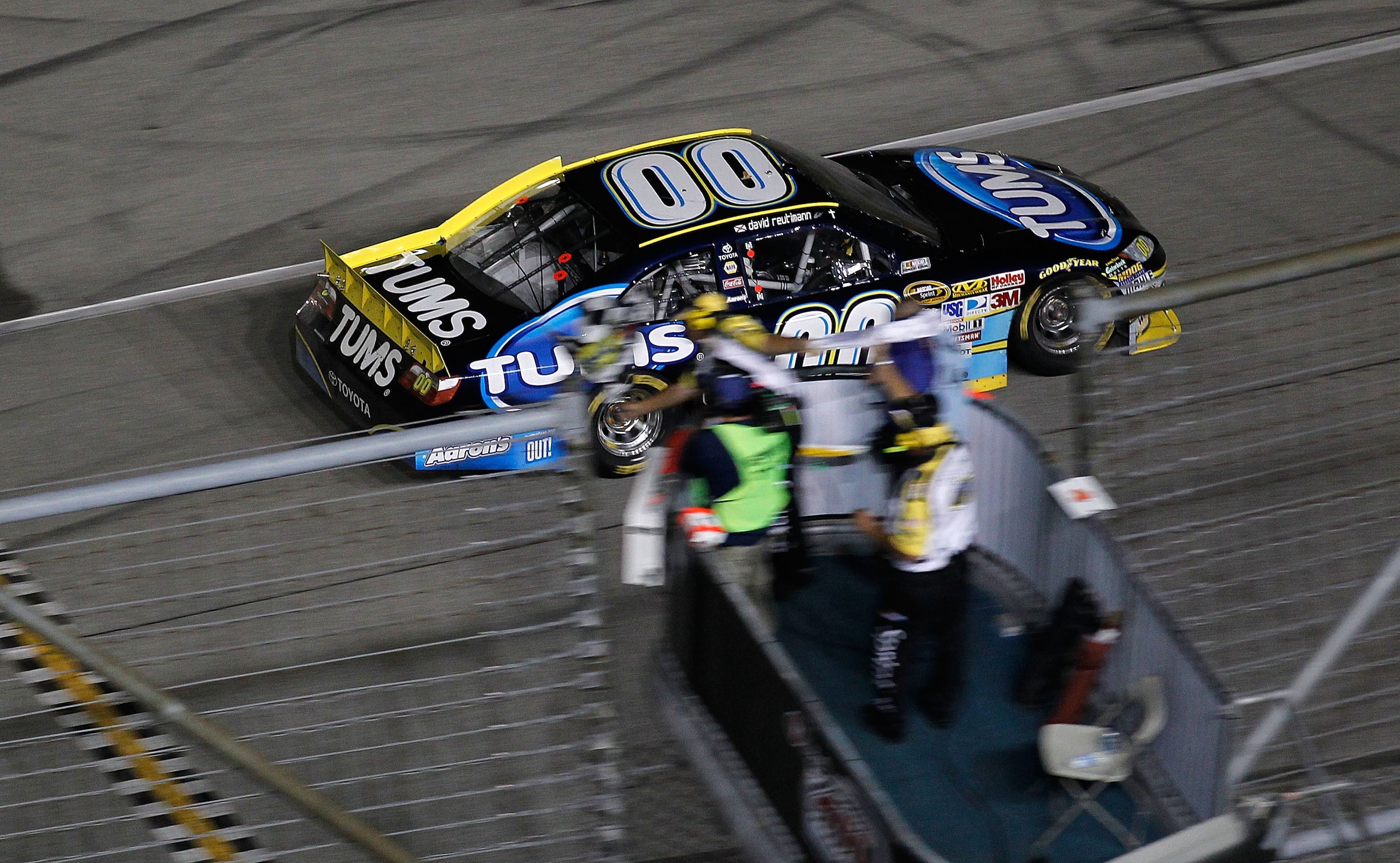 JOLIET, IL - JULY 10:  David Reutimann, driver of the #00 TUMS Toyota, heads across the start/finish line to take the checkered flag and win the NASCAR Sprint Cup Series LIFELOCK.COM 400 at the Chicagoland Speedway on July 10, 2010 in Joliet, Illinois.  (