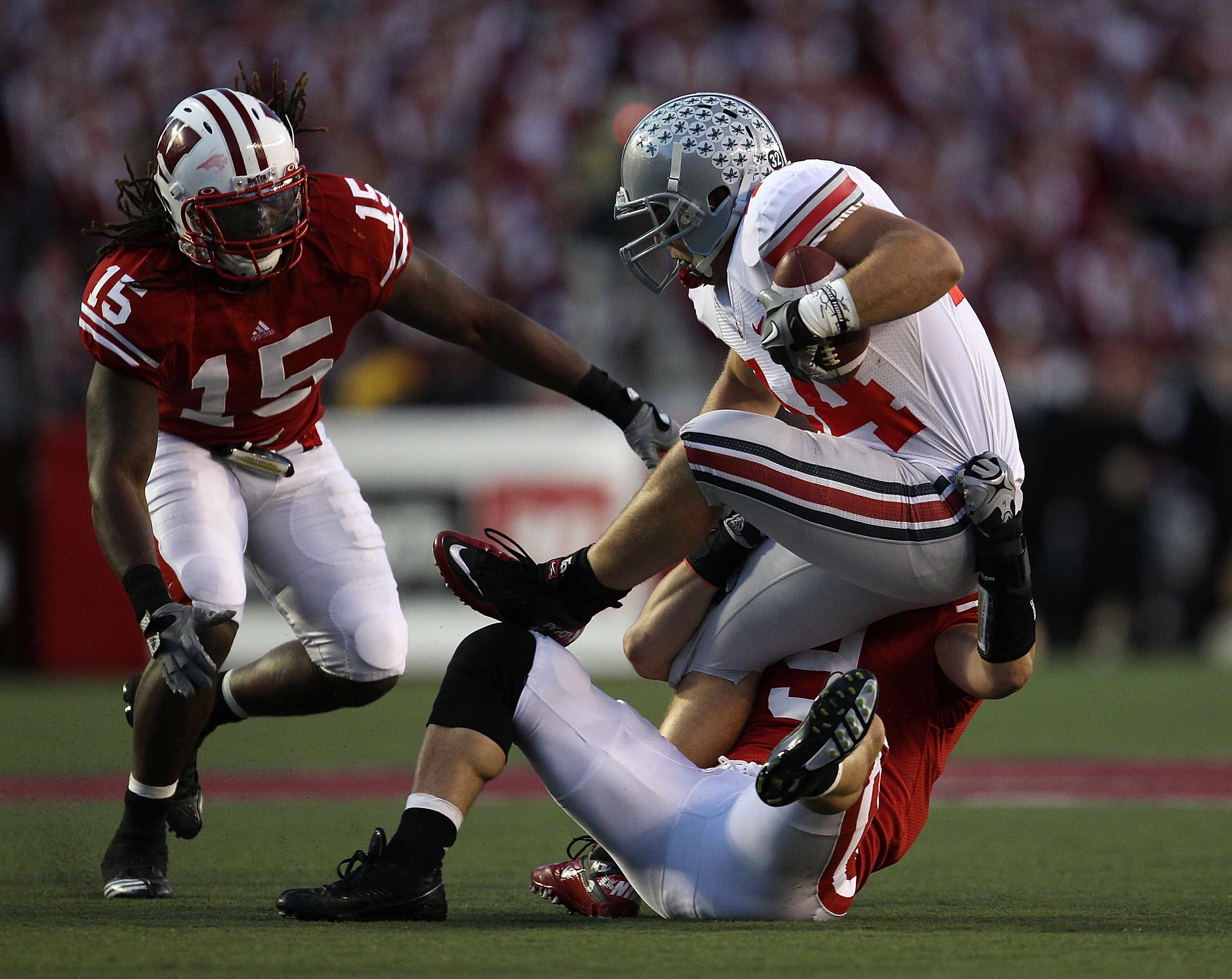 MADISON, WI - OCTOBER 16: Zach Boren #44 of the Ohio State Buckeyes is tackled by Blake Sorensen #9 and Culmer St. Jean #15 of the Wisconsin Badgers at Camp Randall Stadium on October 16, 2010 in Madison, Wisconsin. Wisconsin defeated Ohio State 31-18. (P