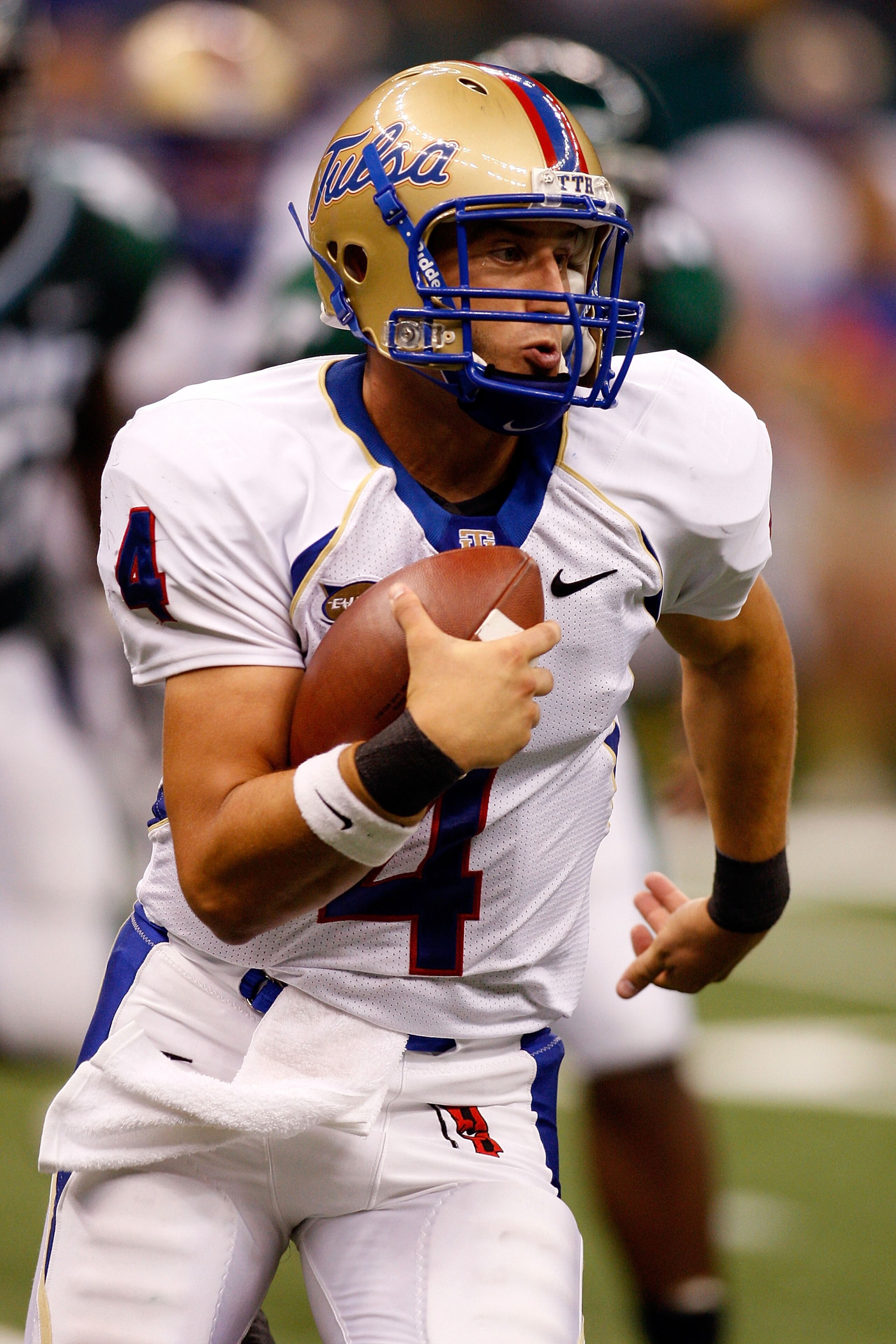 NEW ORLEANS - SEPTEMBER 04:  Quarterback G.J. Kinne #4 of the Tulsa Golden Hurricanes scrambles with the football against the Tulane Green Wave at the Louisiana Superdome on September 4, 2009 in New Orleans, Louisiana.   The Hurricanes defeated the Green