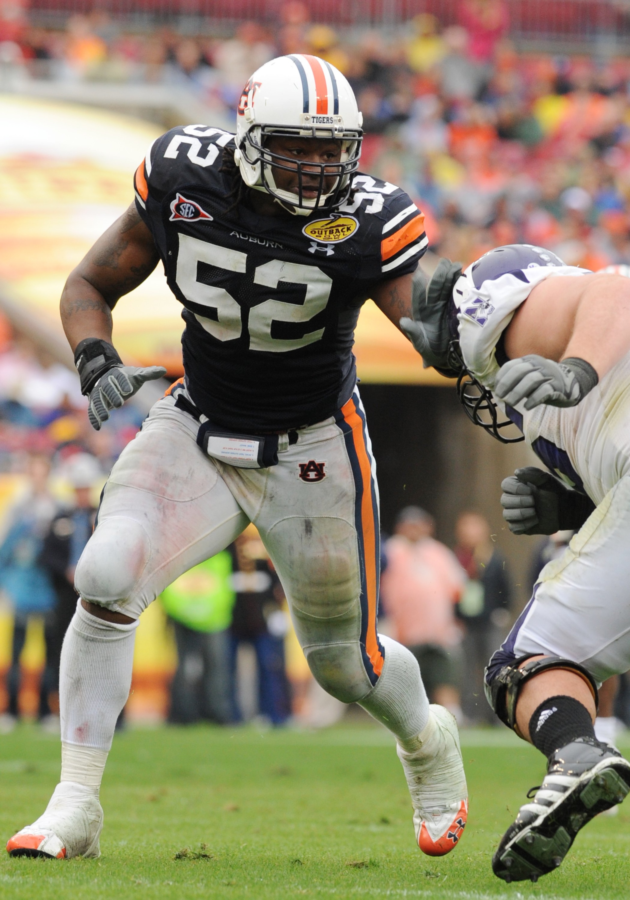 TAMPA, FL - JANUARY 1: Defensive end Antonio Coleman #52 of the Auburn Tigers sets on defense against the Northwestern Wildcats in the Outback Bowl January 1, 2010 at Raymond James Stadium in Tampa, Florida.  (Photo by Al Messerschmidt/Getty Images)
