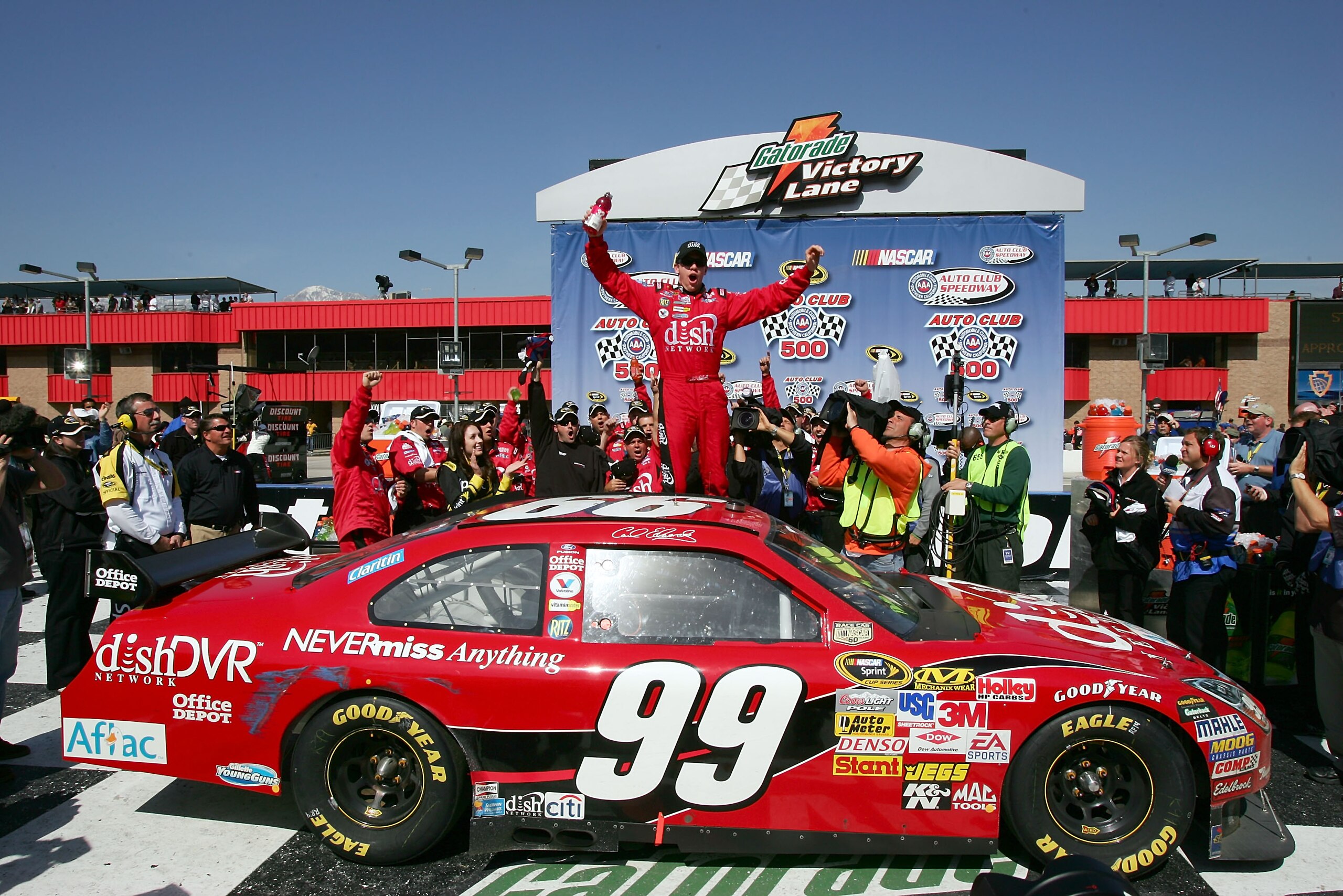 FONTANA, CA - FEBRUARY 25:  Carl Edwards, driver of the #99 Dish Network Ford, celebrates in victory lane after winning the NASCAR Sprint Cup Series Auto Club 500 at the Auto Club Speedway of Southern California on February 25, 2008 in Fontana, California